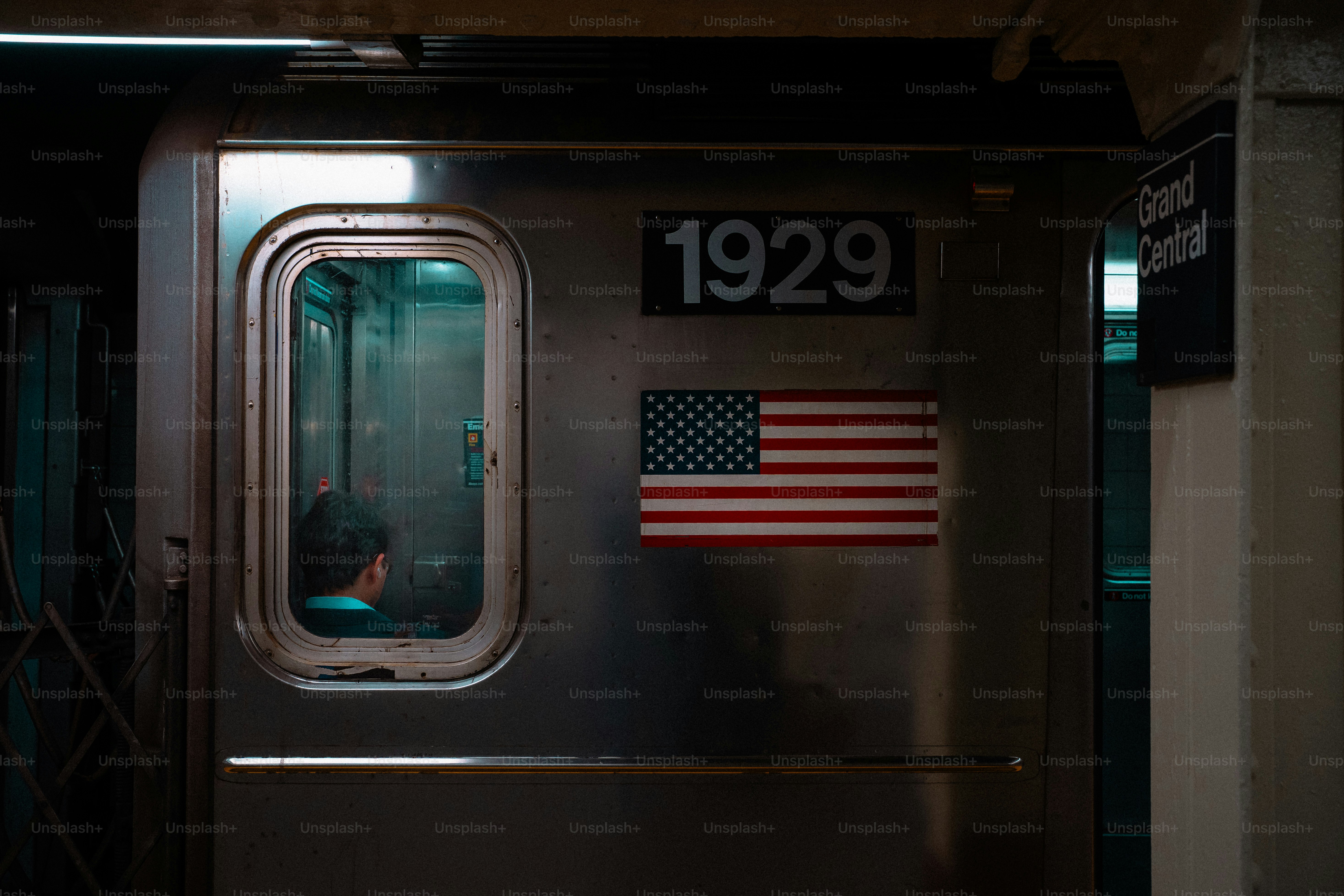 Subway car door with number 1929 and american flag.