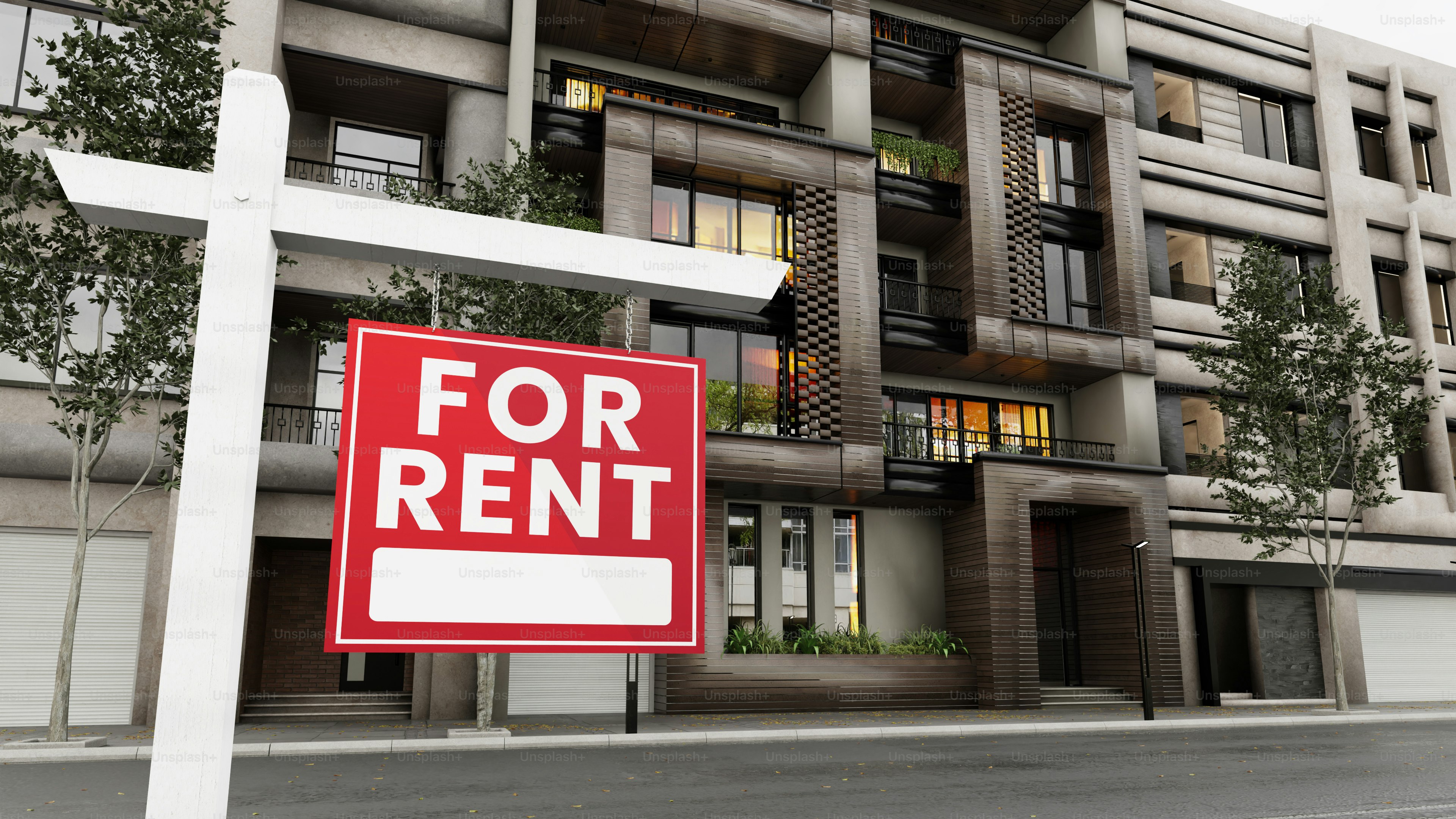Panneau « Louer » devant un immeuble moderne