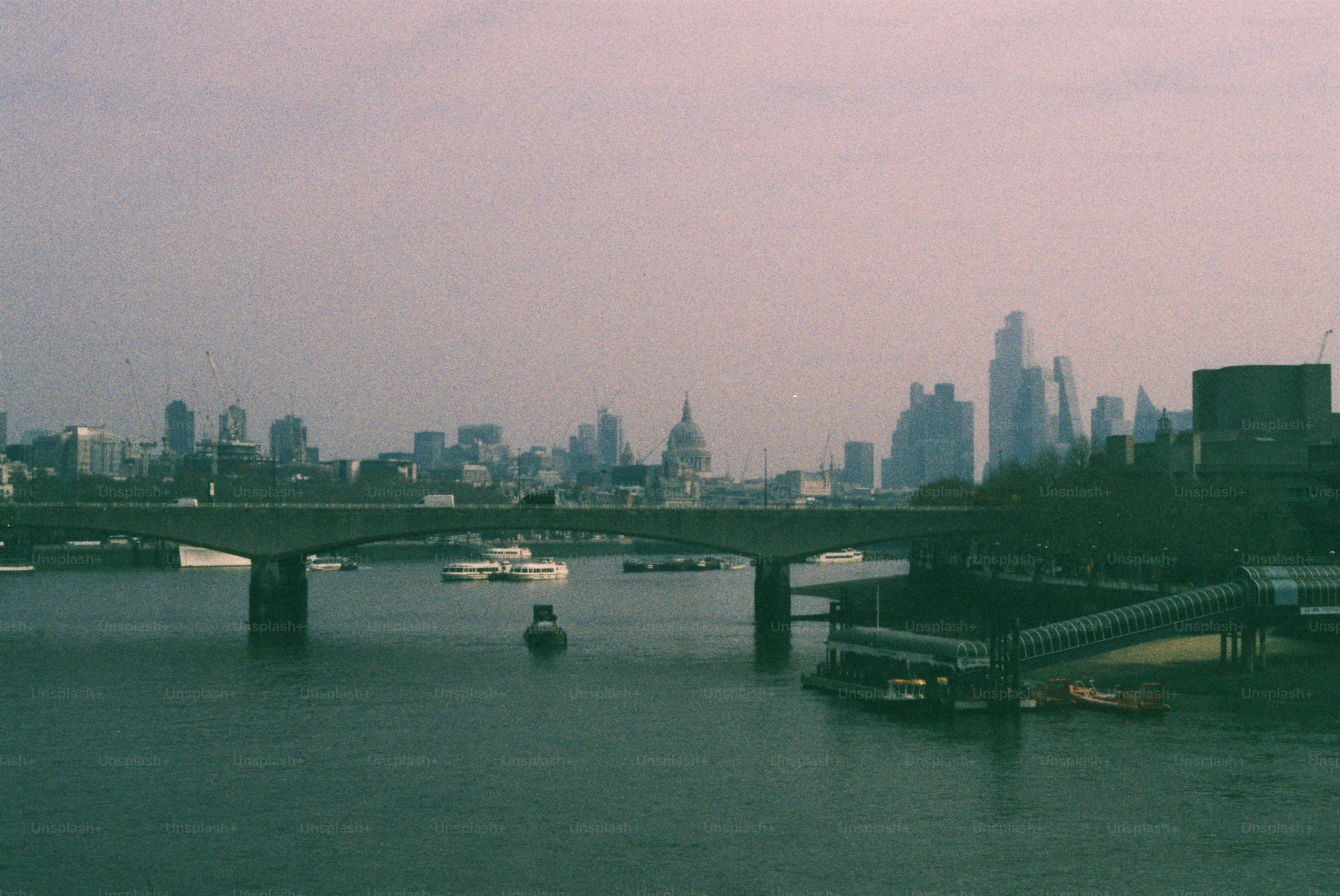 City skyline with a river and bridge photo – Buildings Image on Unsplash