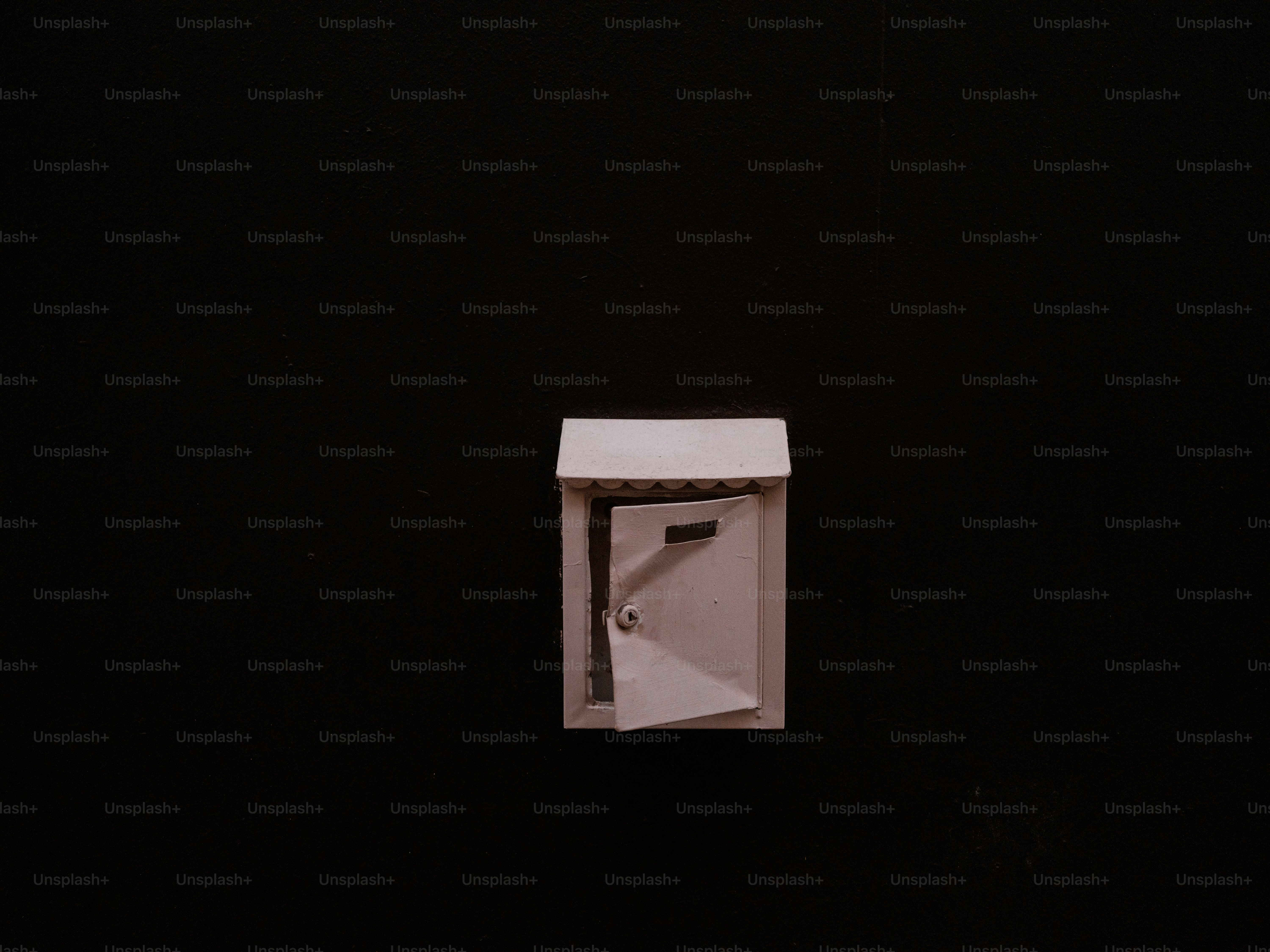 A miniature outhouse with the door ajar