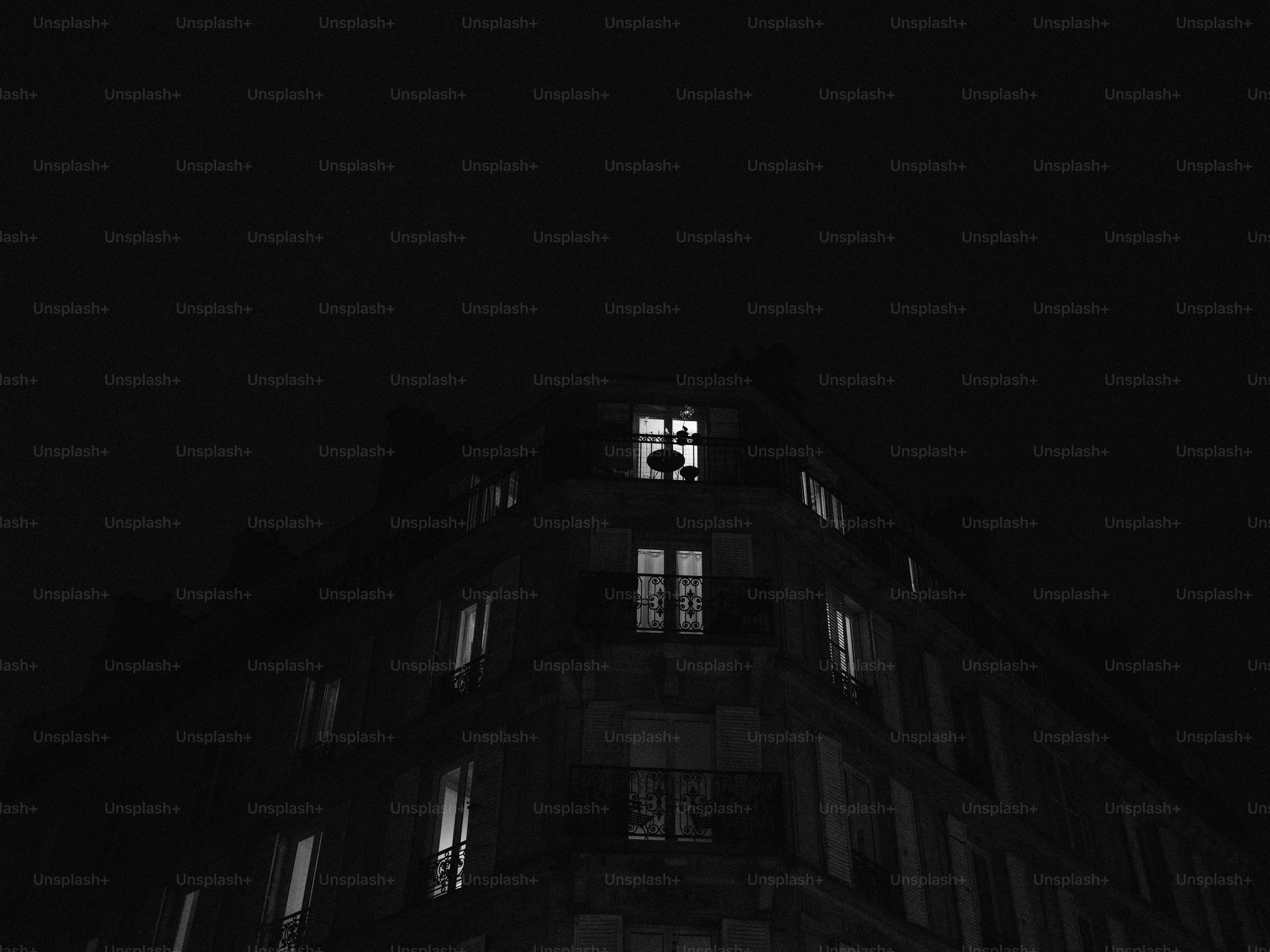 Dark building with illuminated windows at night photo – Travel Image on ...