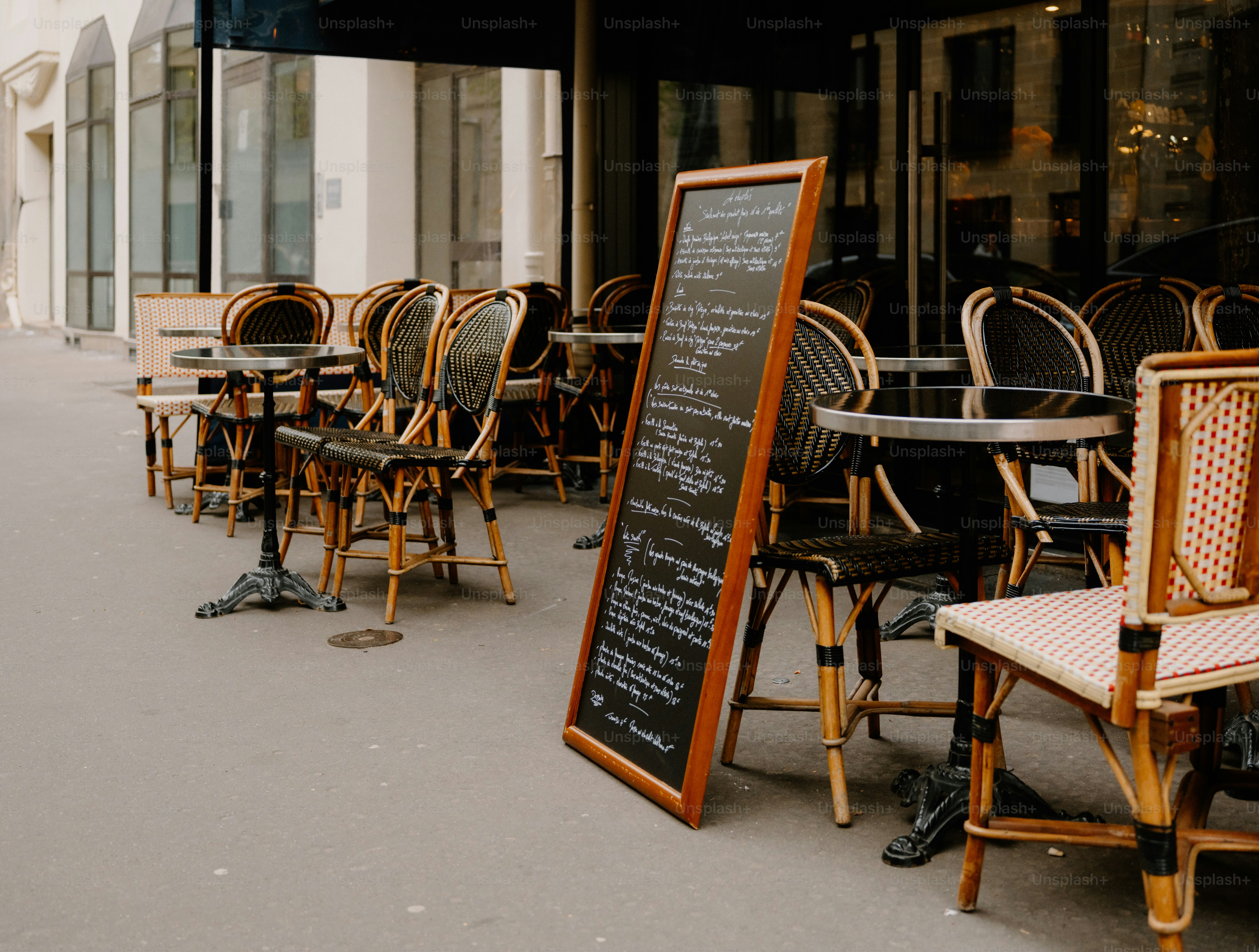 Mesas y sillas de café al aire libre con un menú