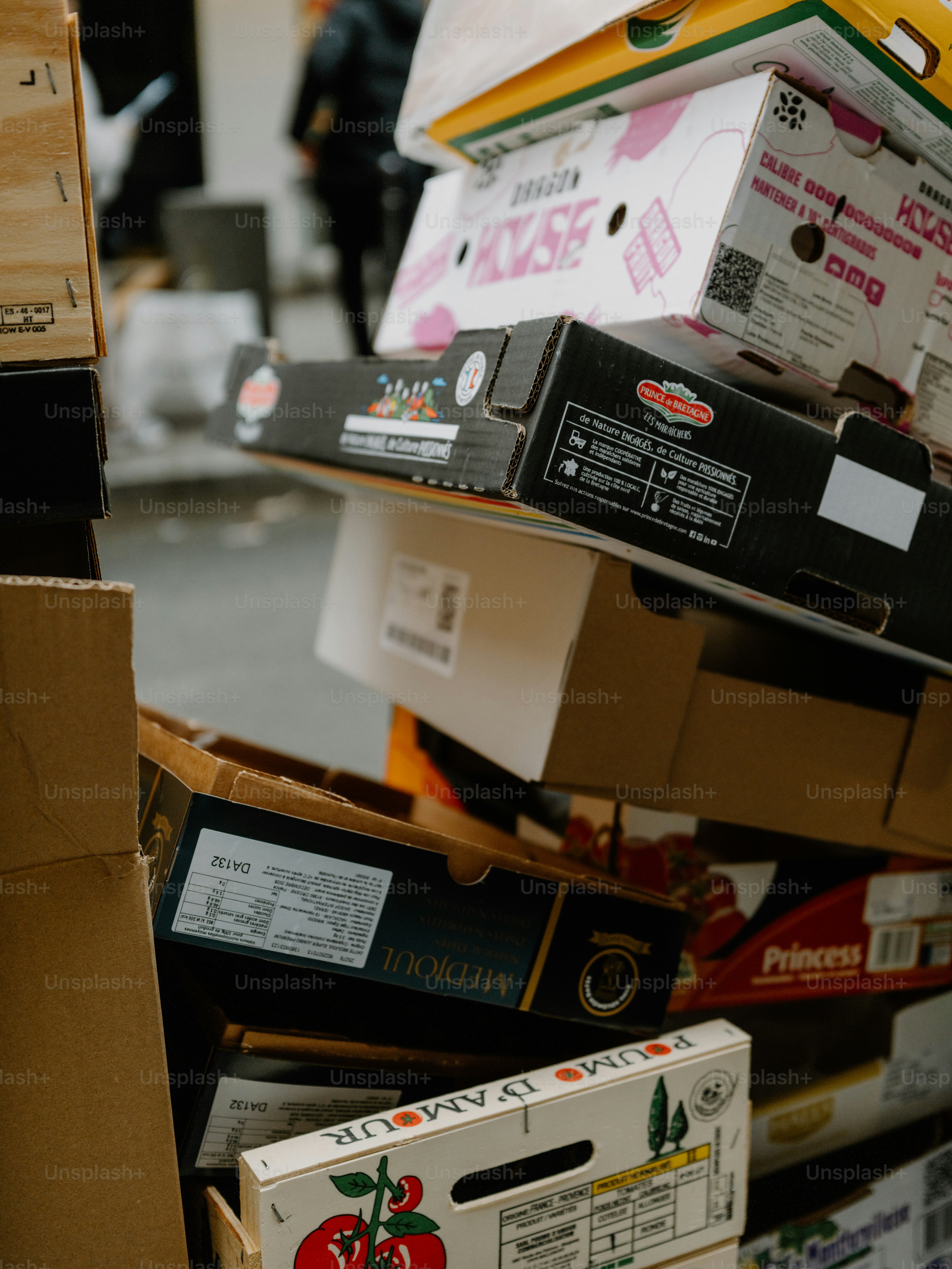 A pile of stacked cardboard boxes with produce labels. photo ...