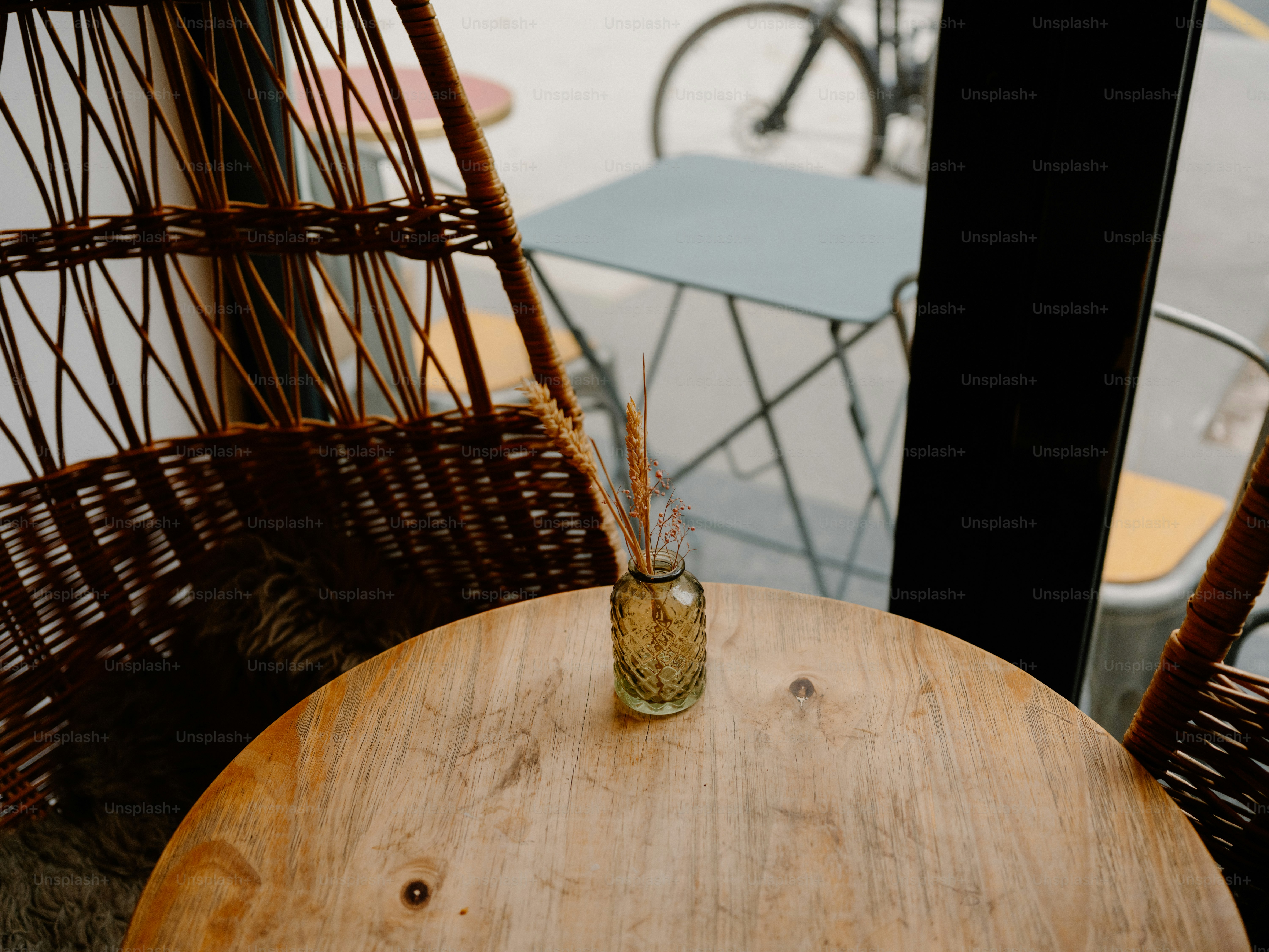 Small vase with dried grass on a wooden table