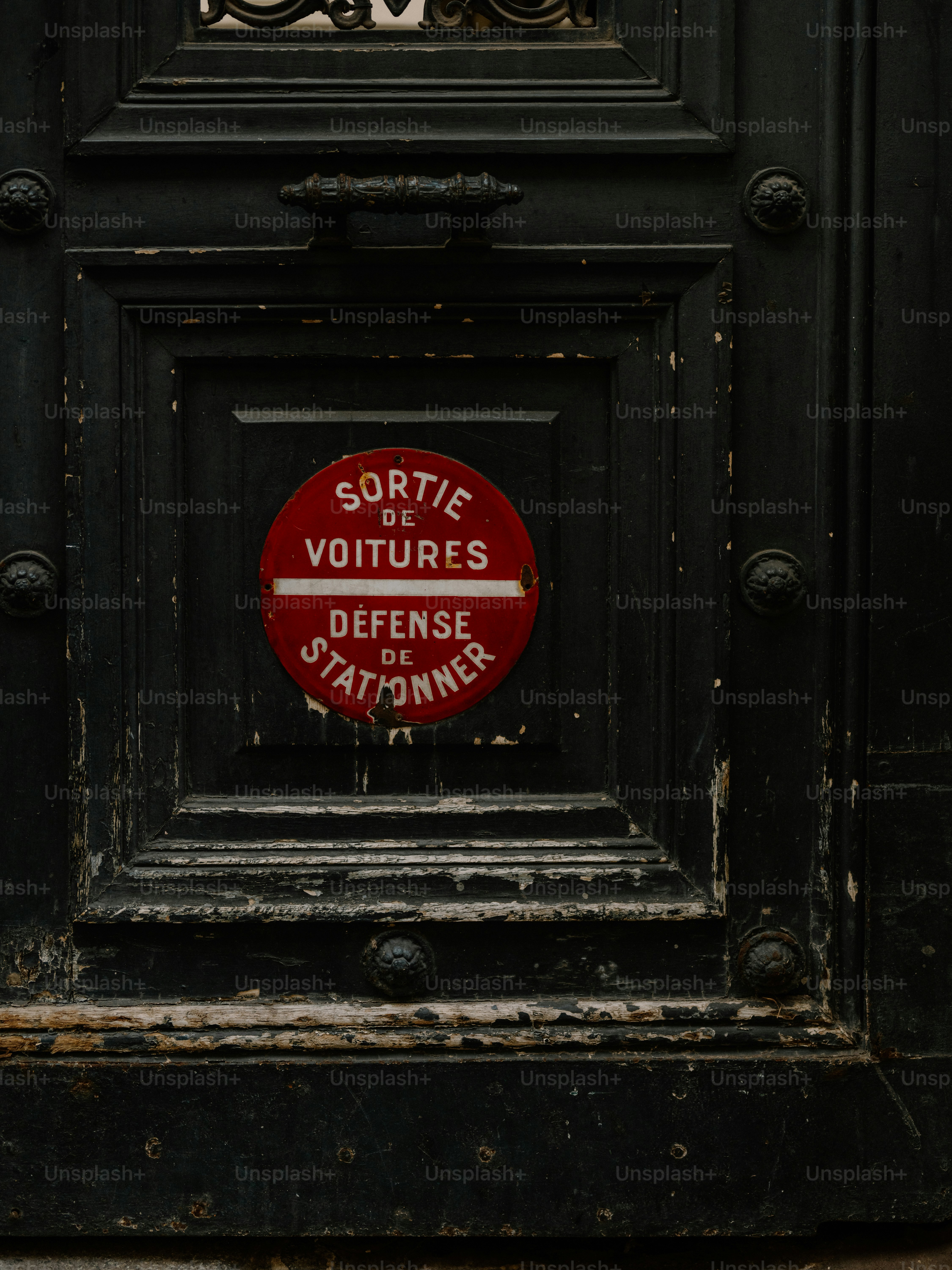 A red sign on a dark wooden door