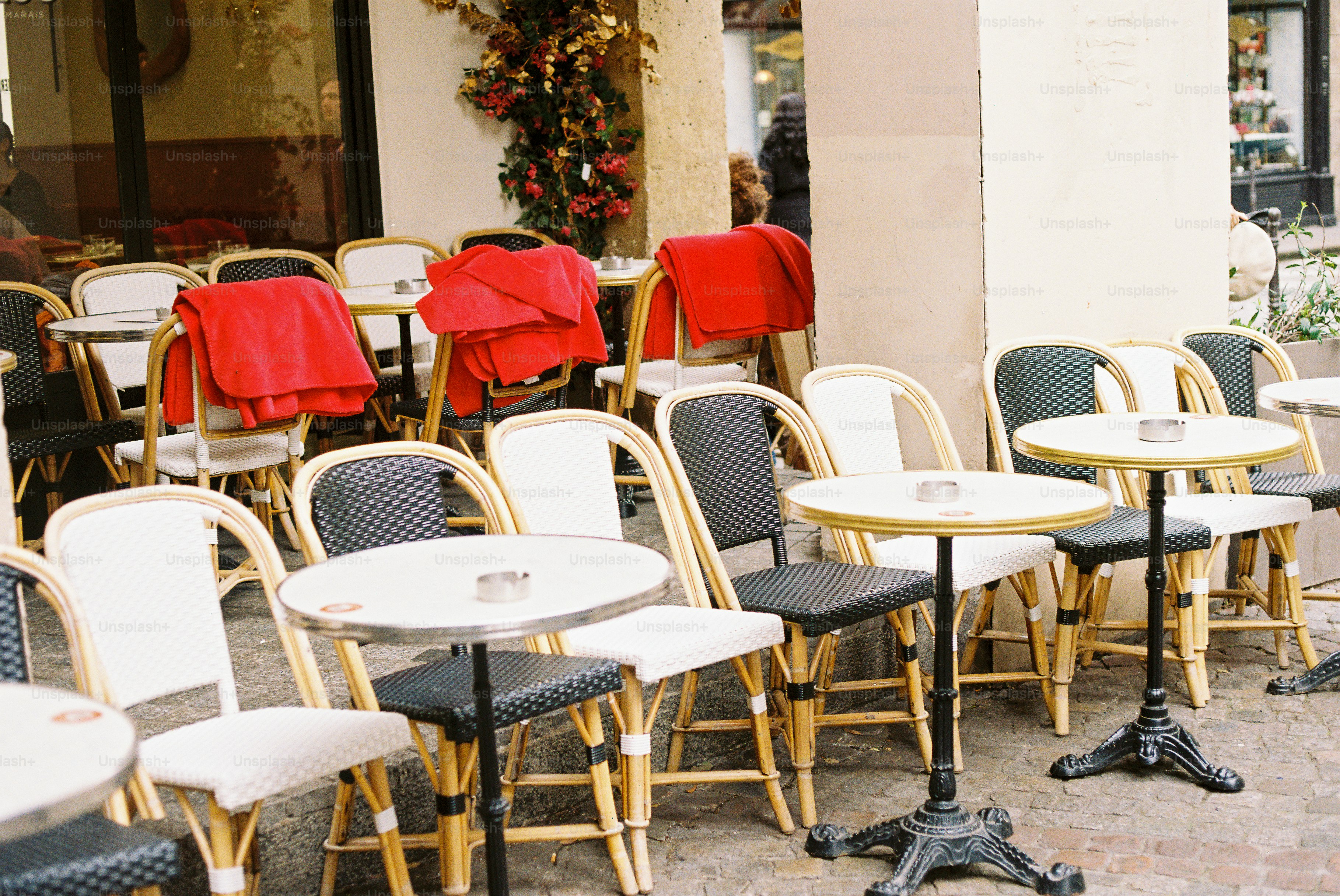 Empty outdoor cafe tables and chairs with red blankets photo – Cafe ...