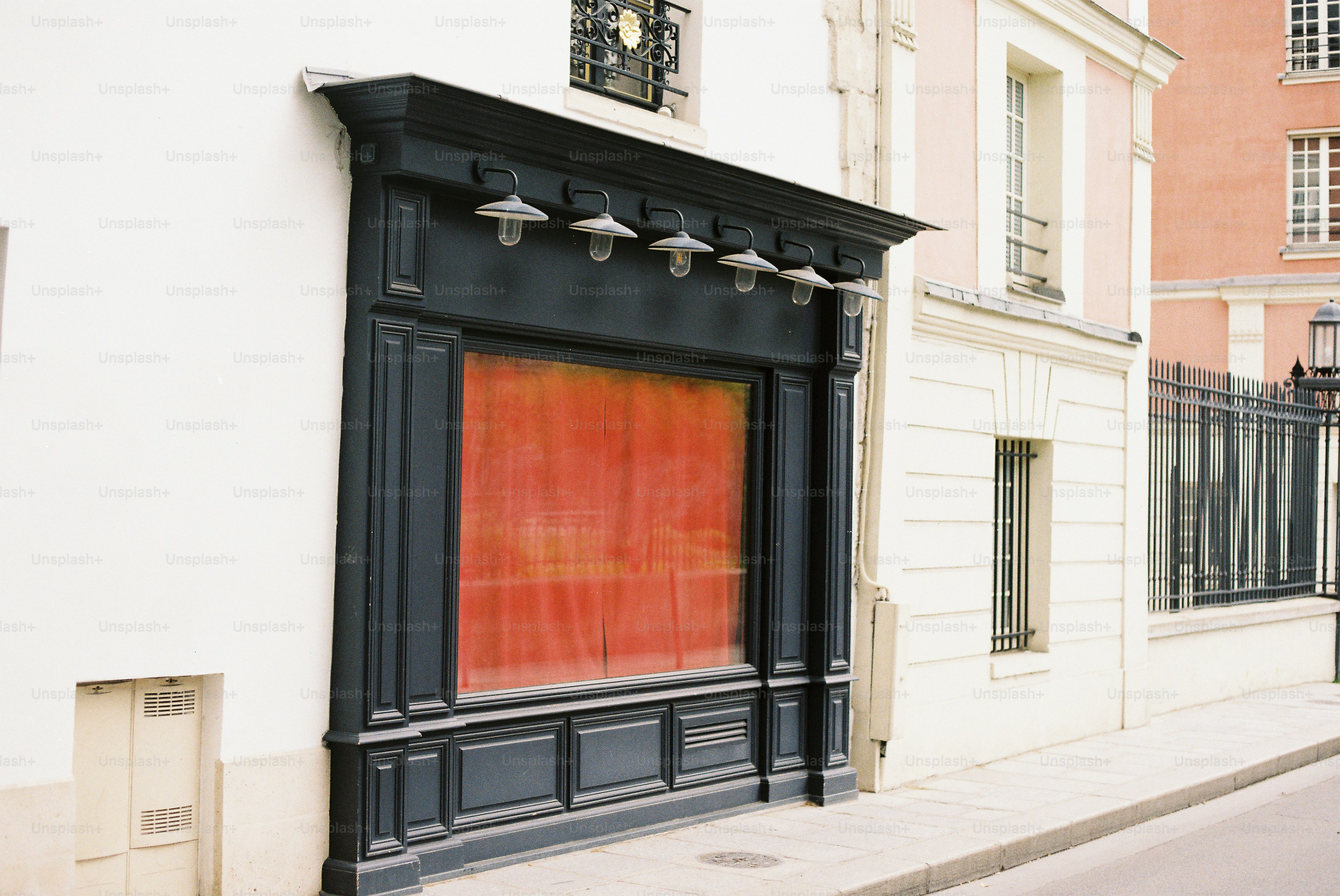 A storefront with a red curtain behind glass. photo – Architecture ...