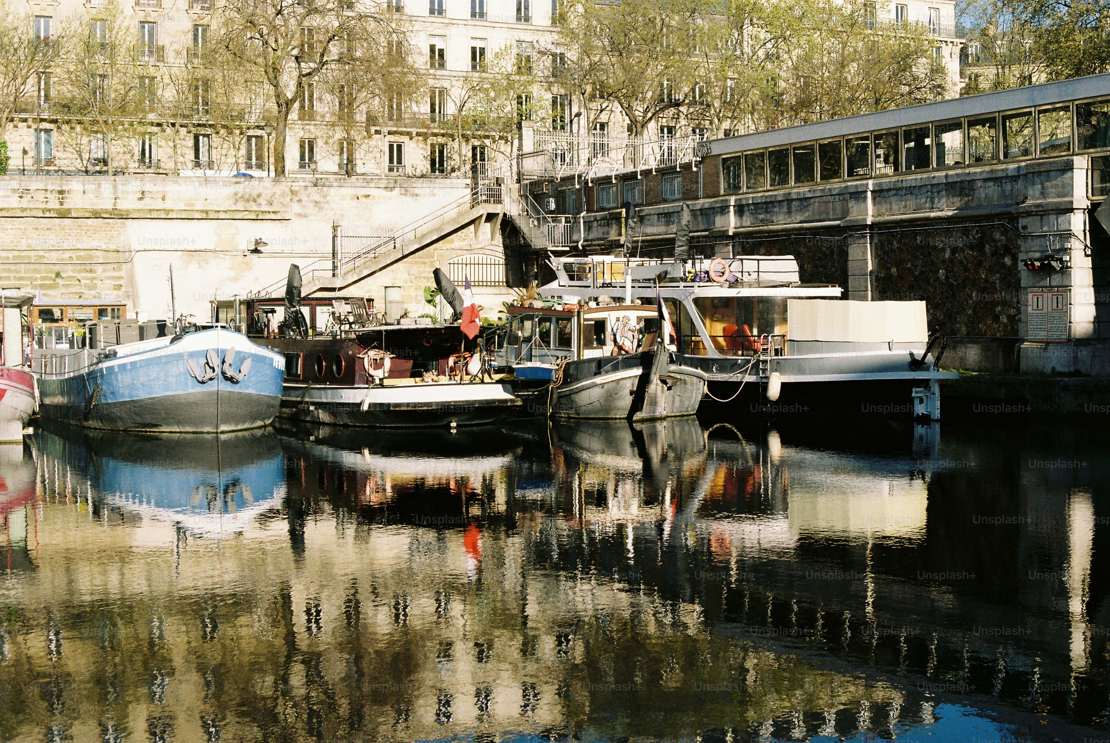Boats docked on a river with reflections