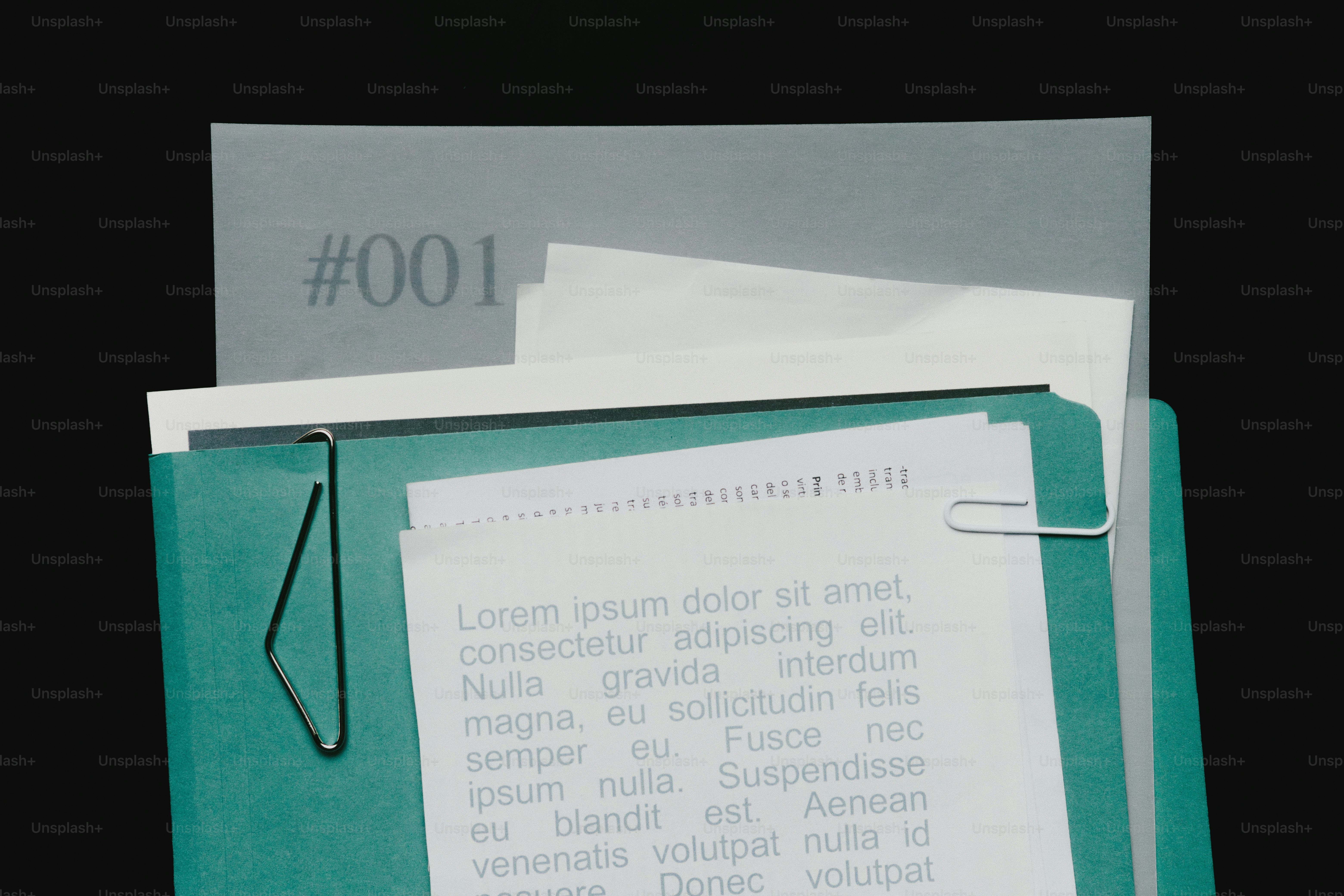 Folder with documents and paperclip on black background photo ...