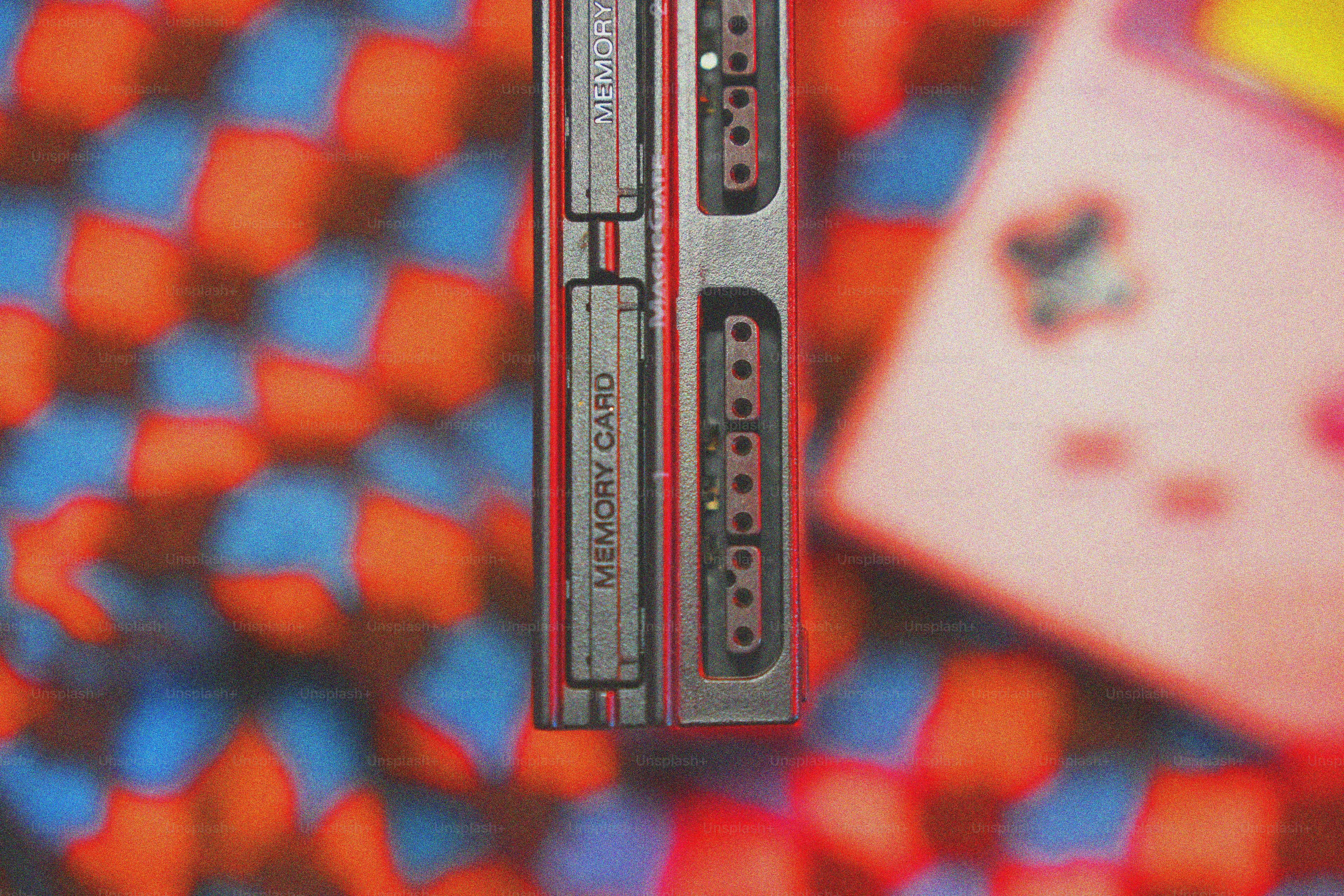 Konsol game retro dan kartu memori dengan latar belakang kotak-kotak