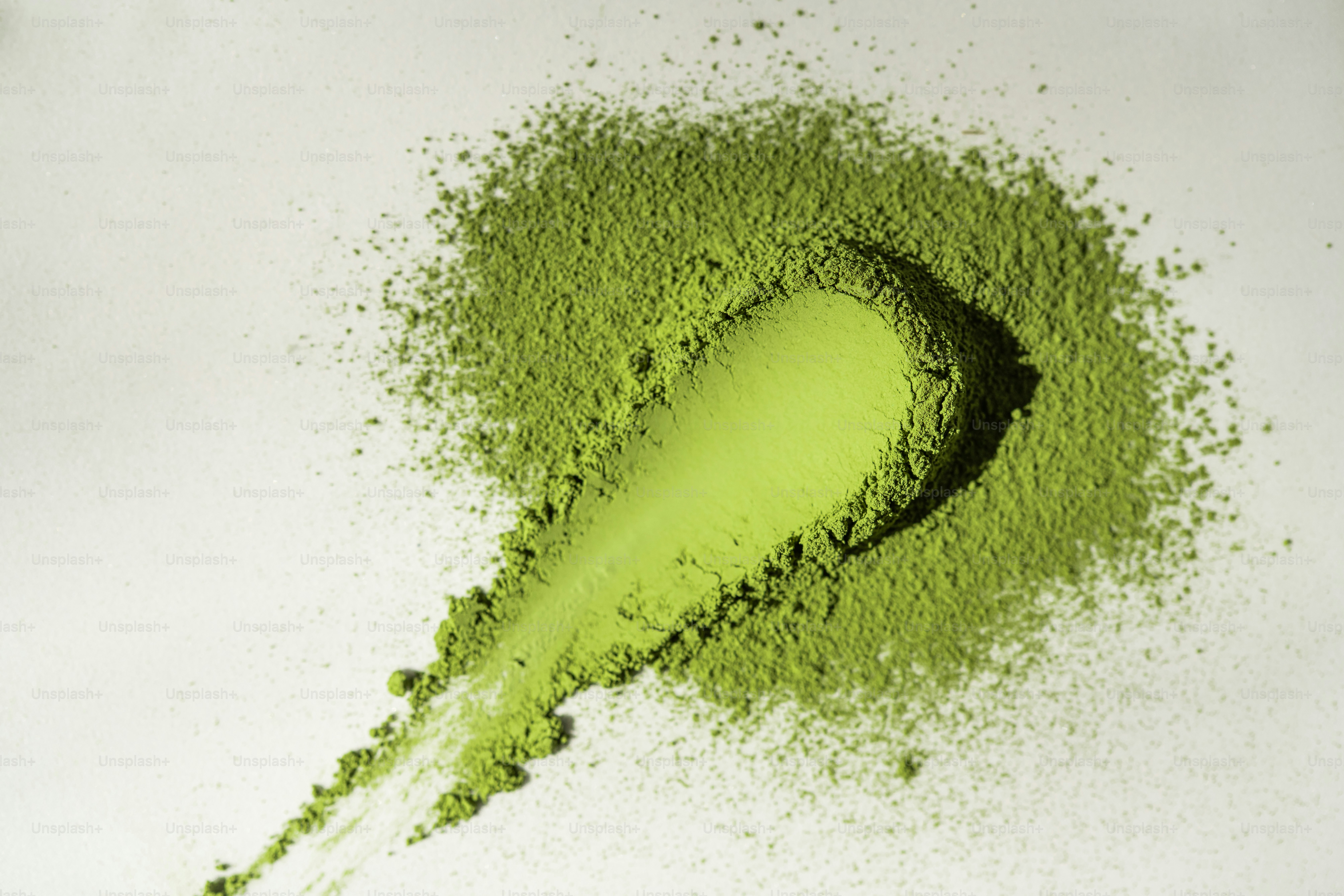 A vibrant green powder swatch on a white background photo – Healthy ...