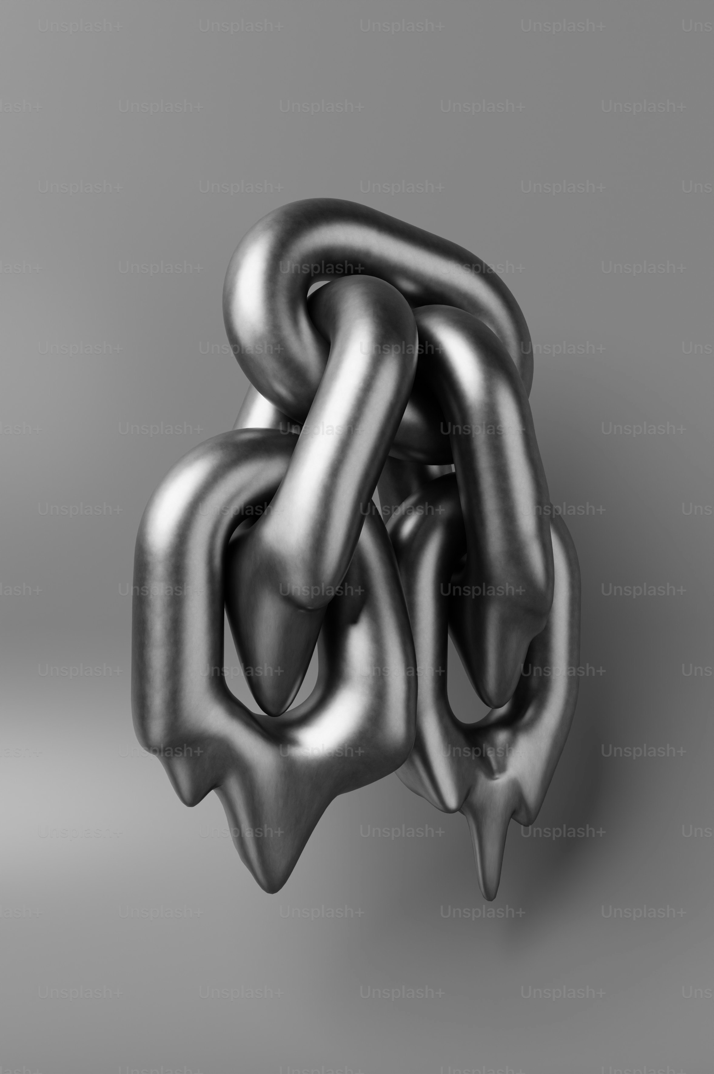 A metallic chain melting against a gray background.