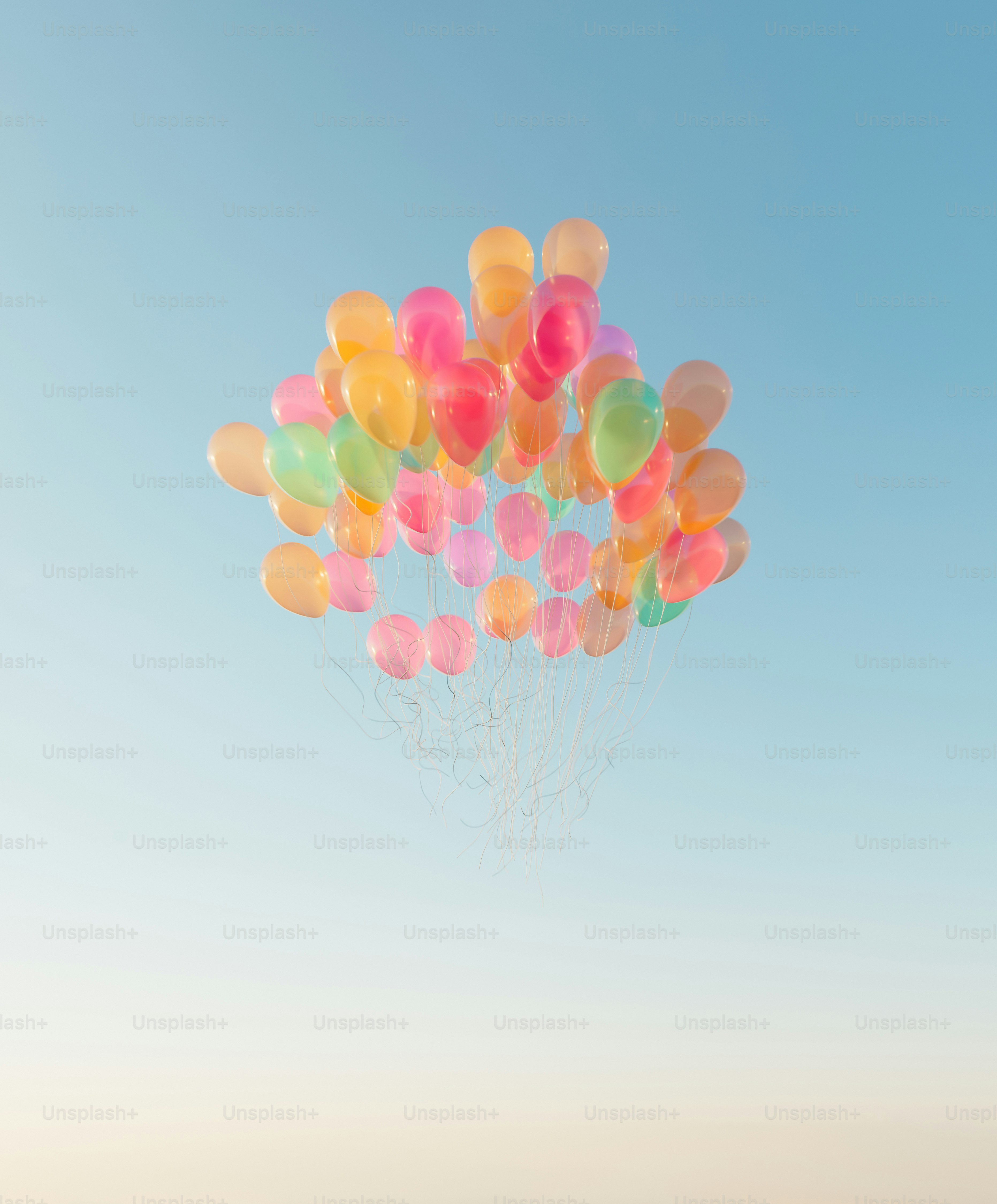 A cluster of colorful balloons floating in a clear sky.