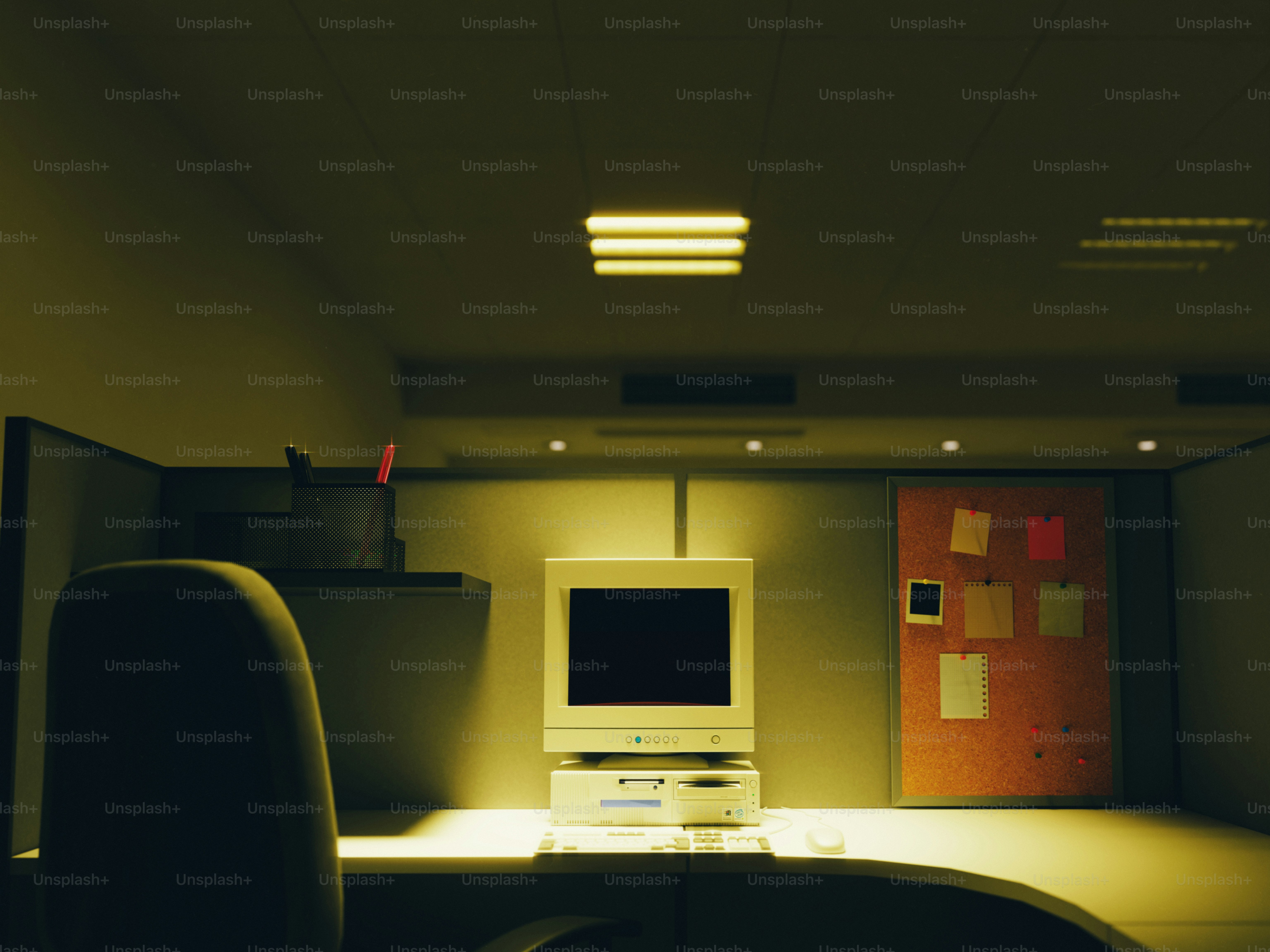 Vintage computer on a desk in a dimly lit office.