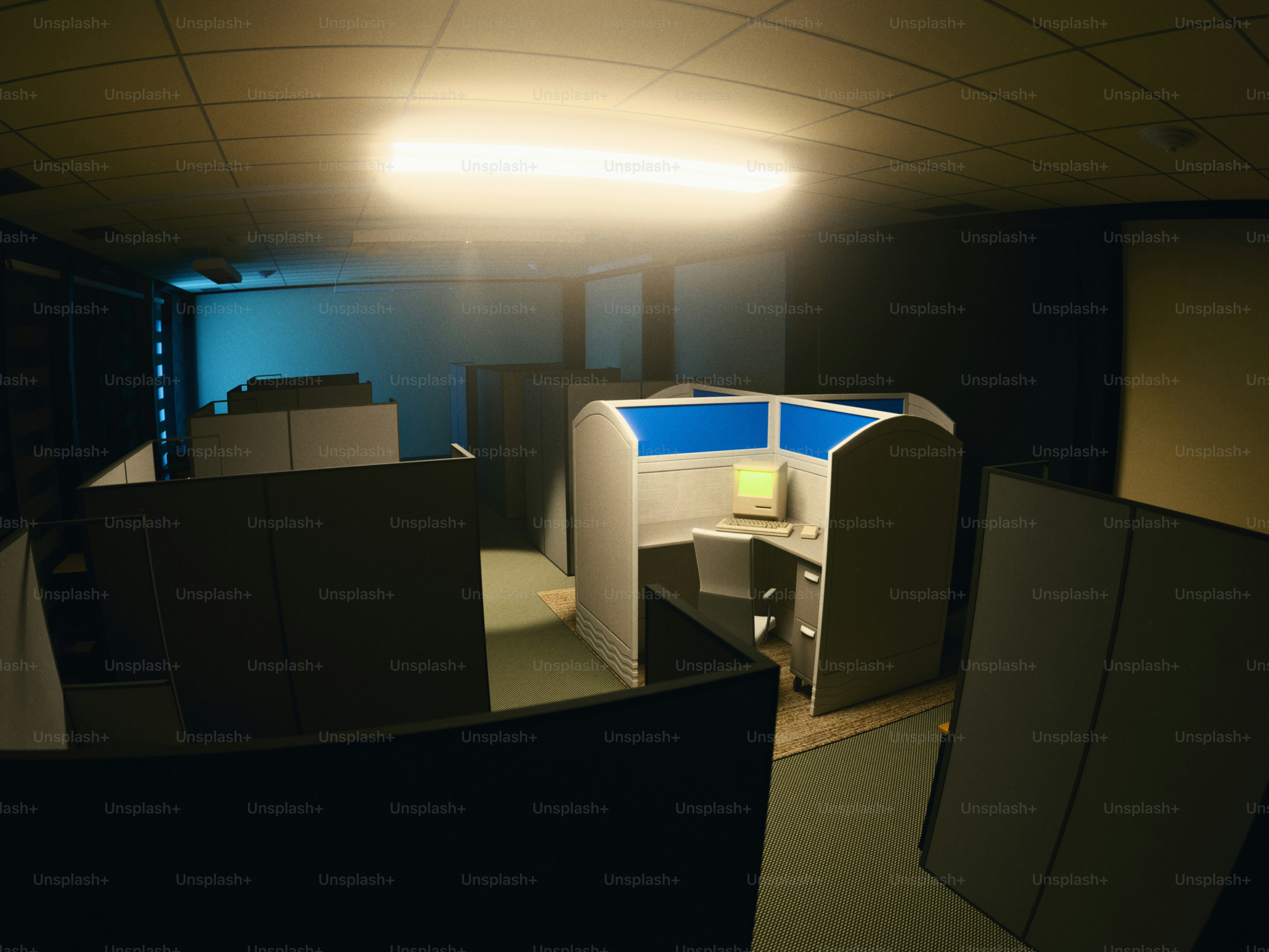Empty office cubicles with computer monitors
