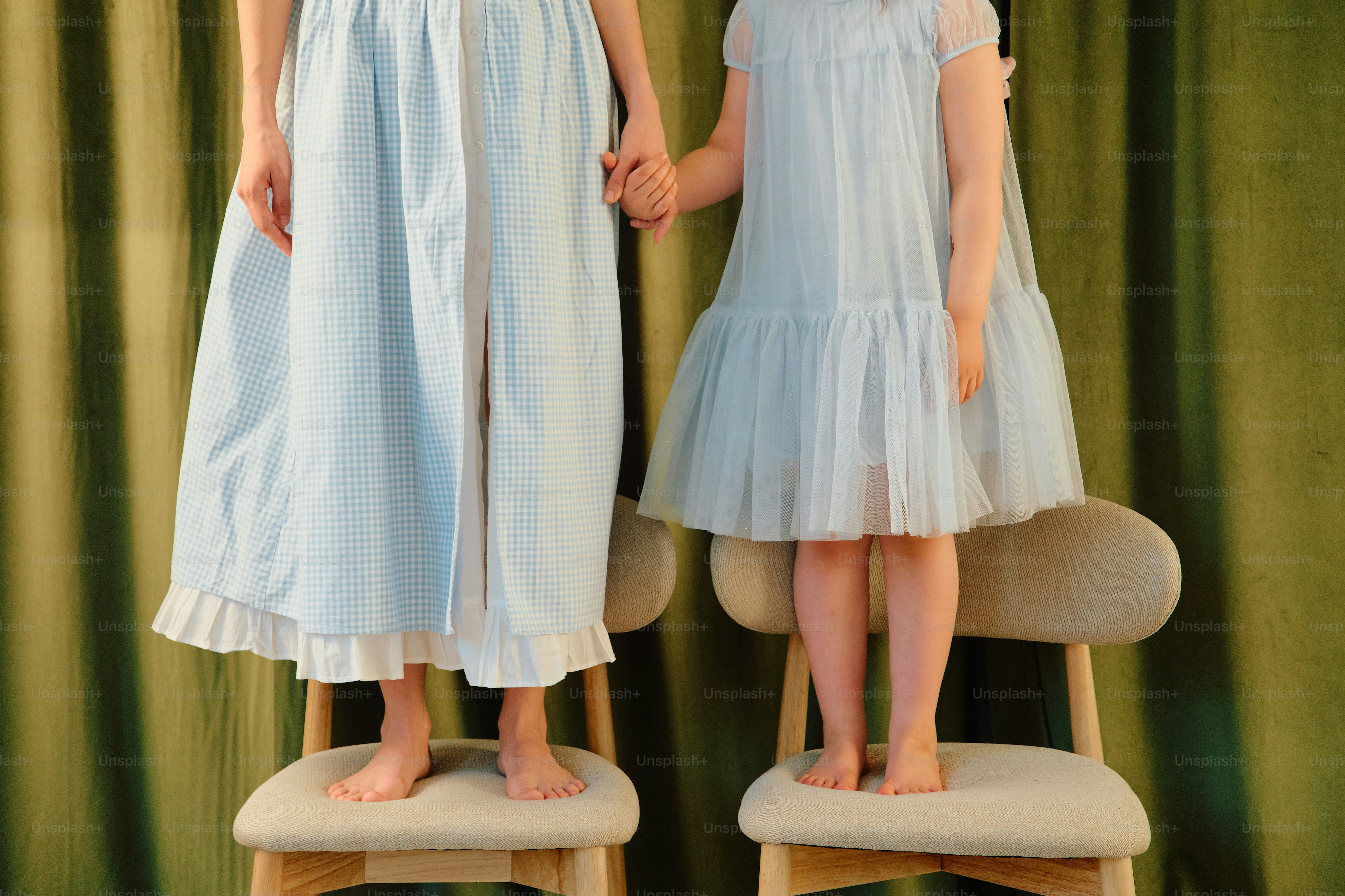 Two girls in light blue dresses holding hands photo – Family Image on ...