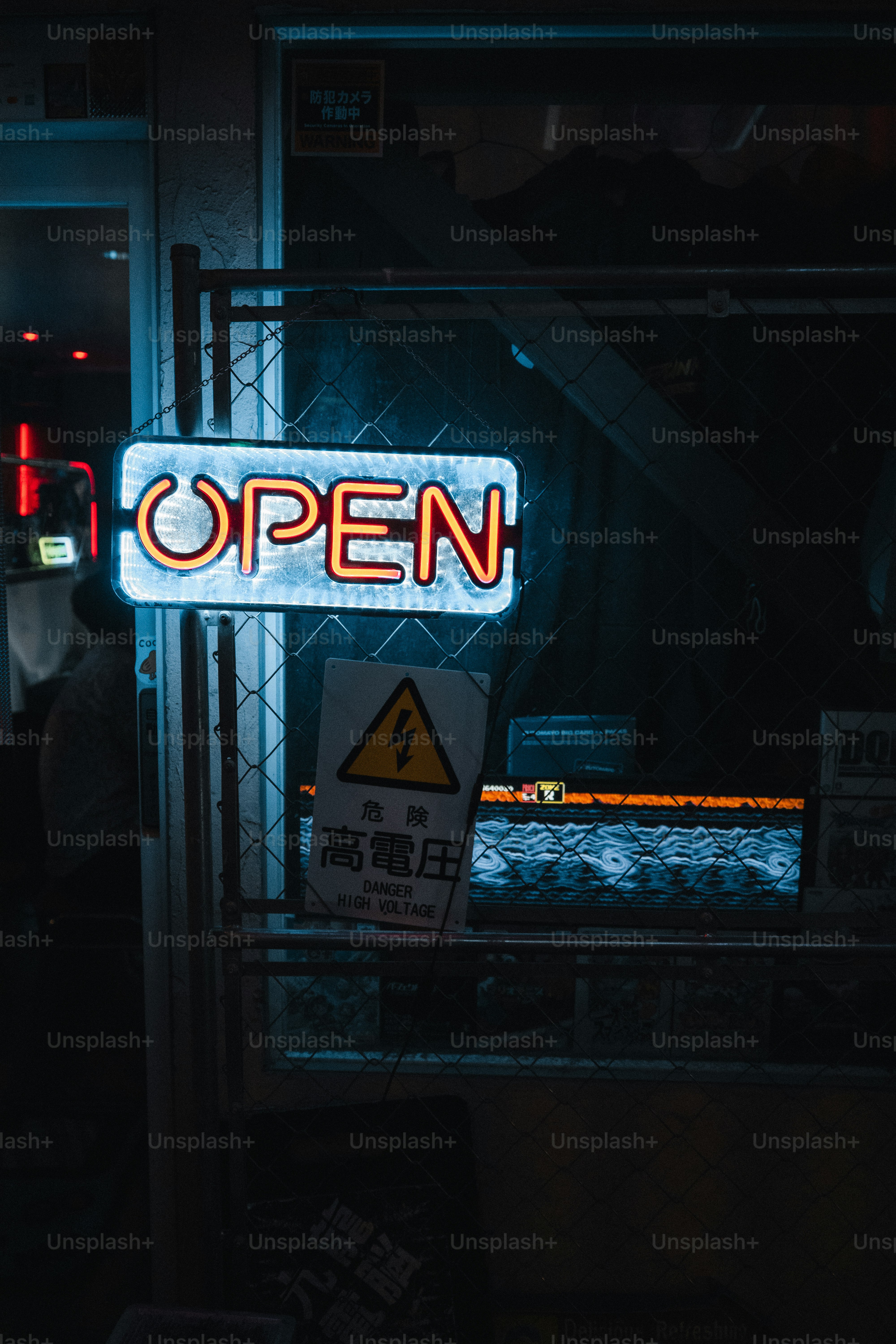 An "open" neon sign glows at night.