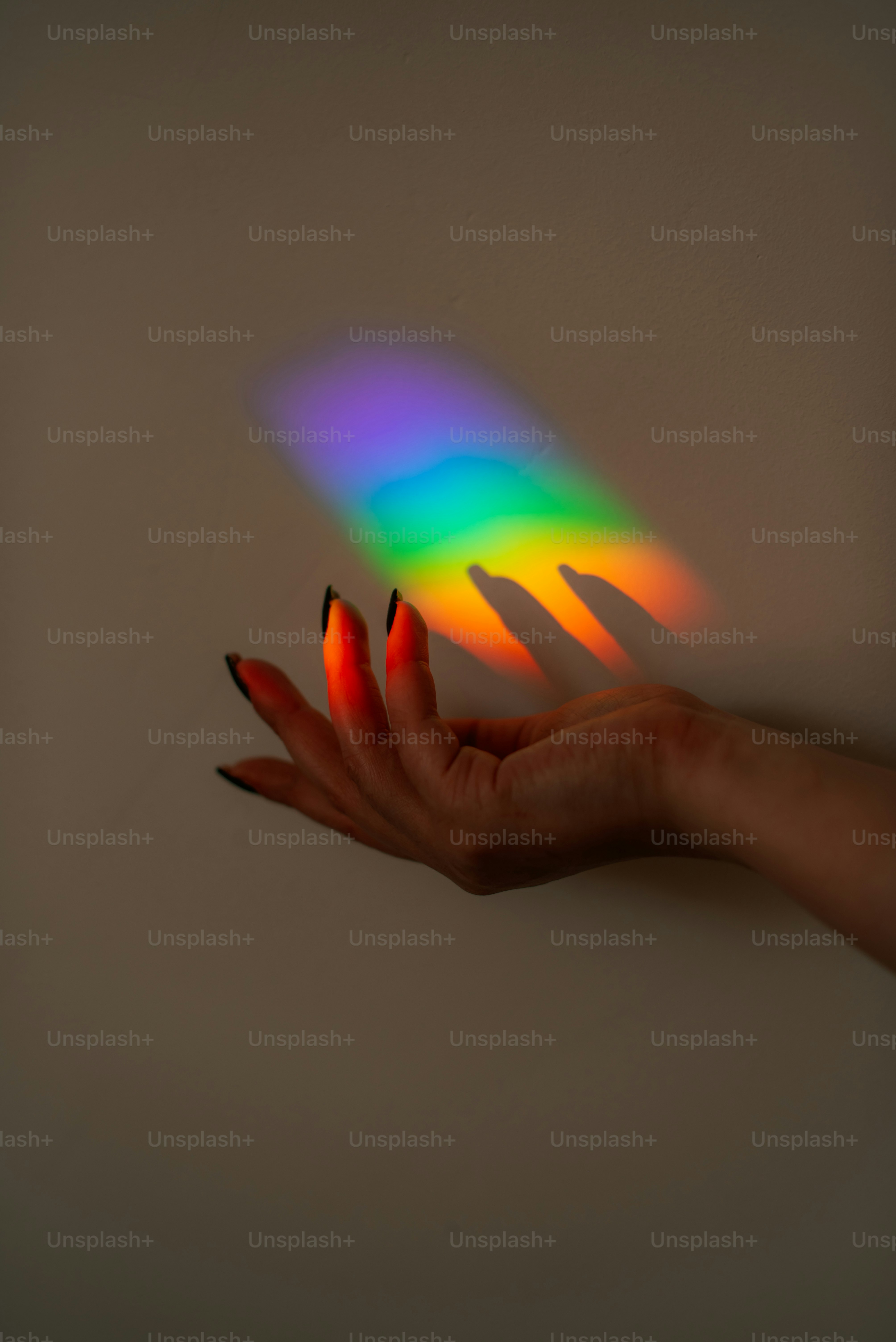 Hand reaching into a rainbow light spectrum. photo – Hand Image on Unsplash
