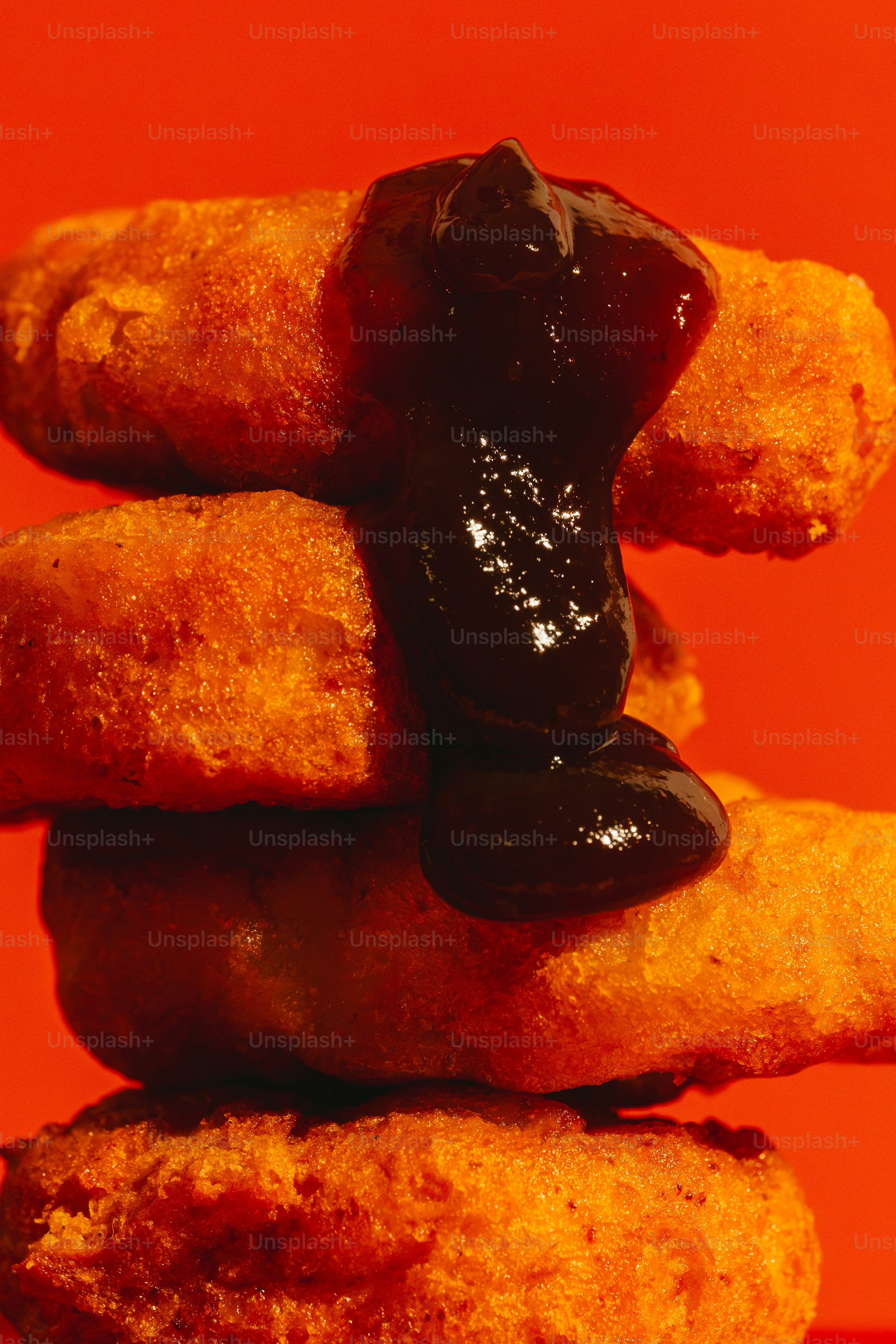 Stack of fried chicken nuggets with dark sauce