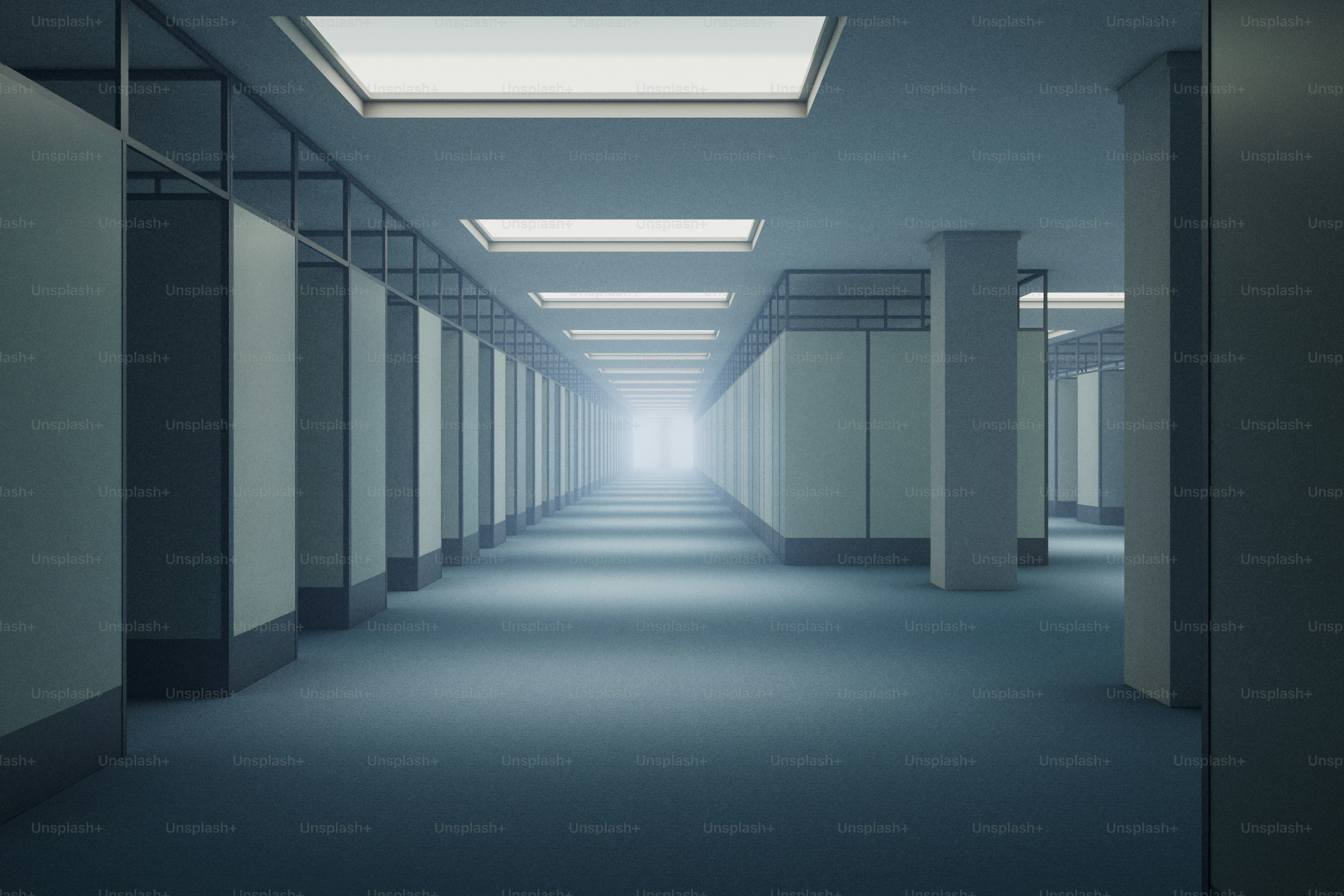 Long, empty office hallway with bright lights.