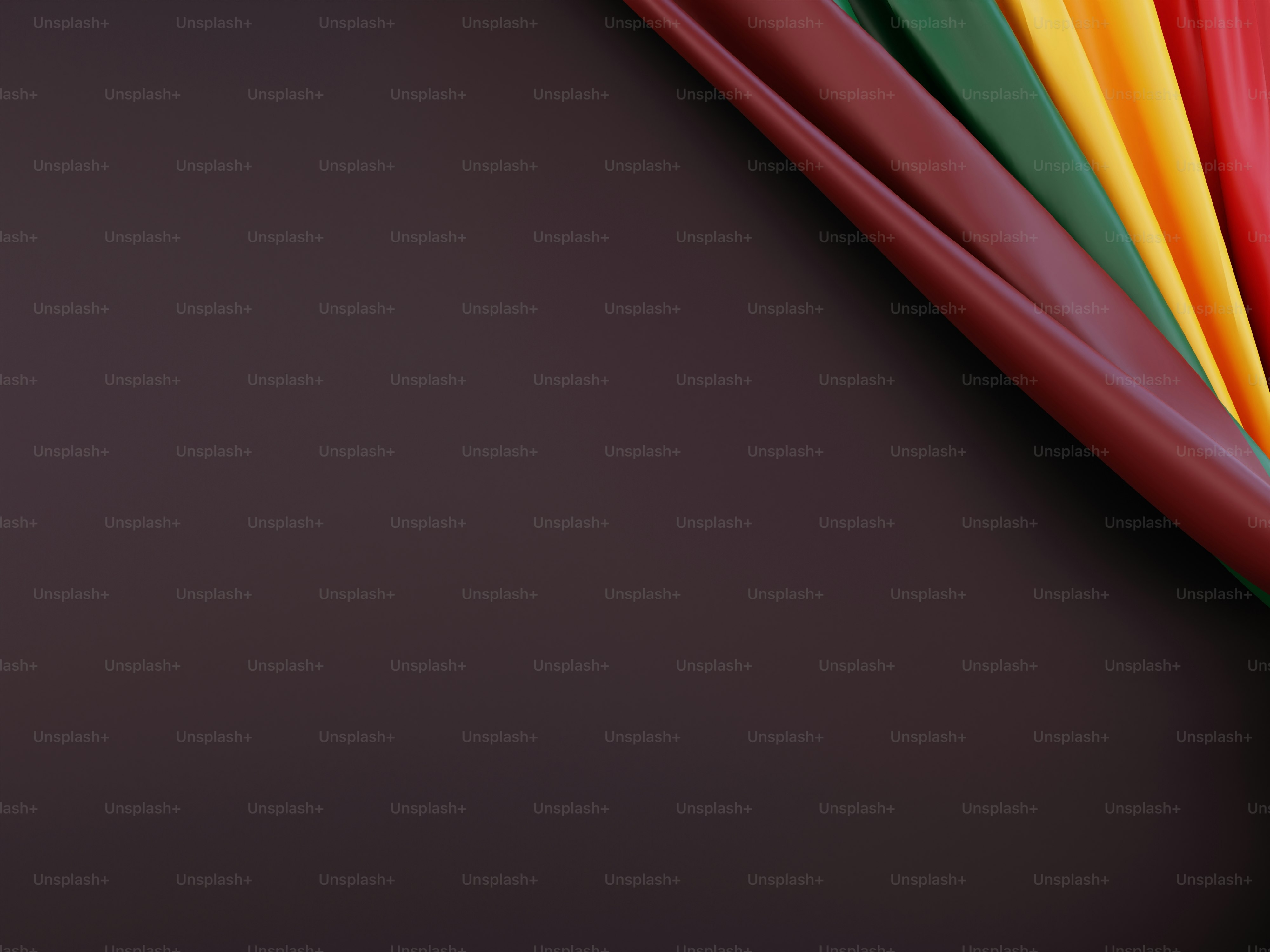 Colorful ribbons arranged diagonally on a dark background.