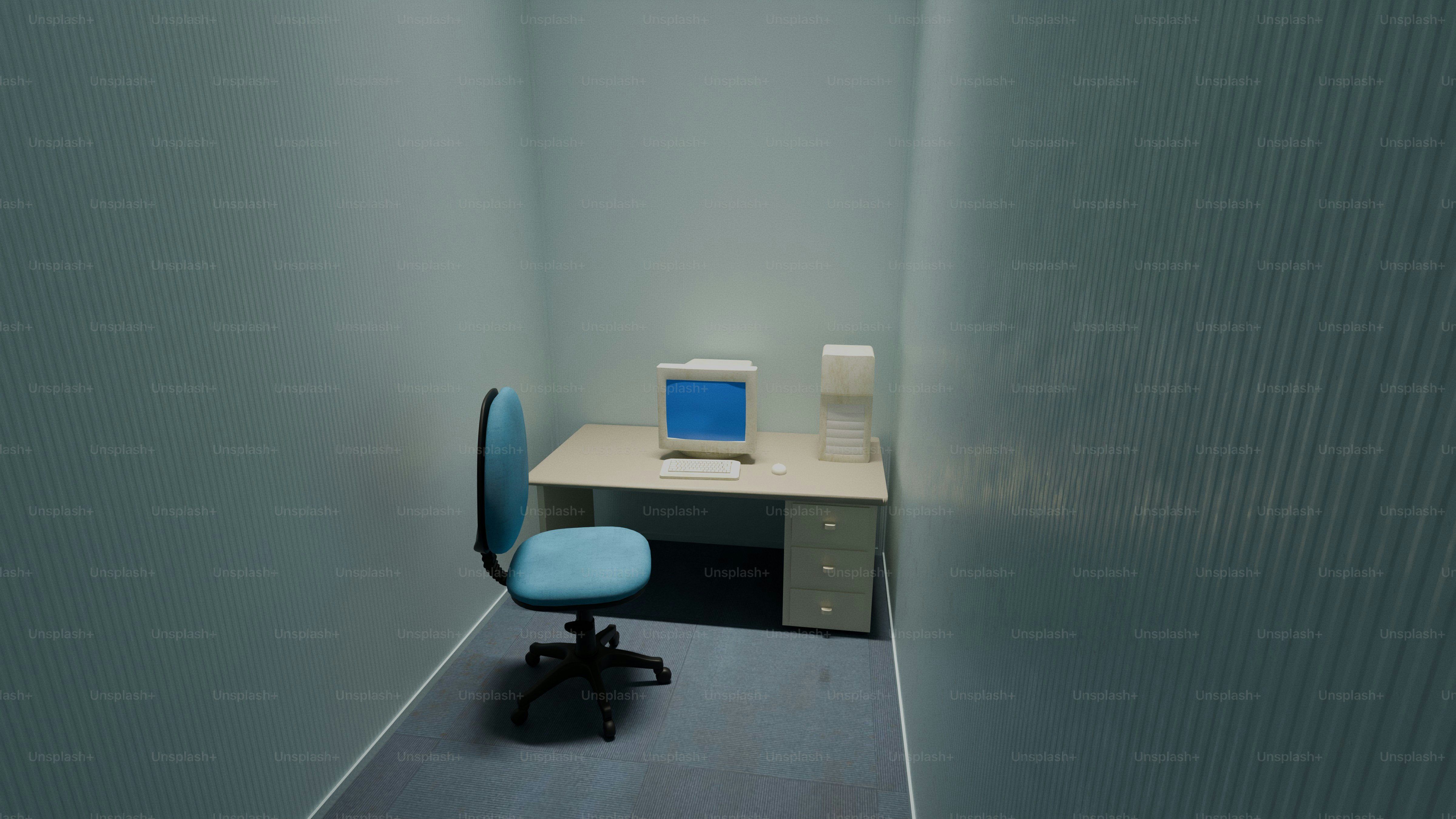 A small office with a desk, chair, and computer.