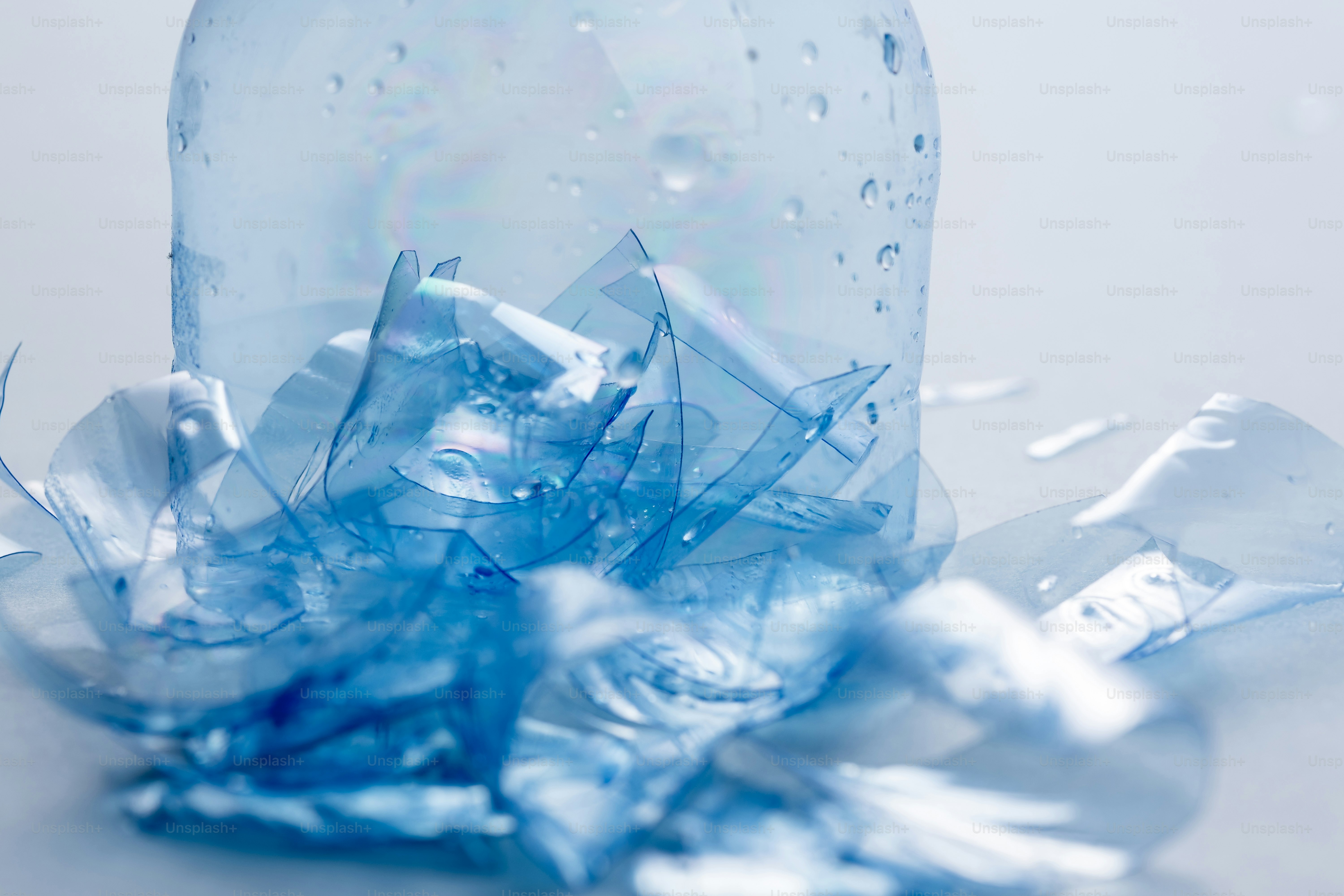 Crushed plastic bottle with water droplets