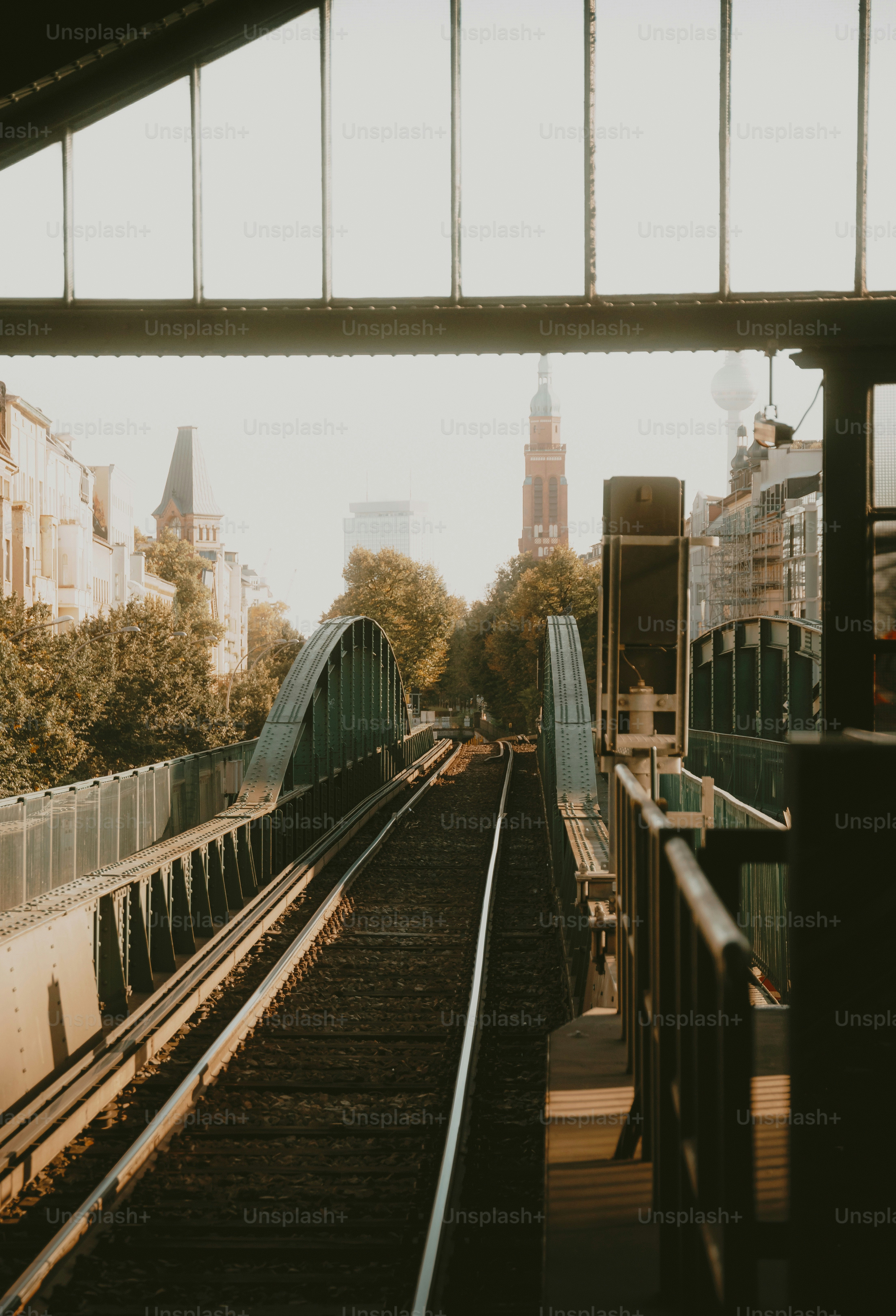 Train tracks leading to a city skyline