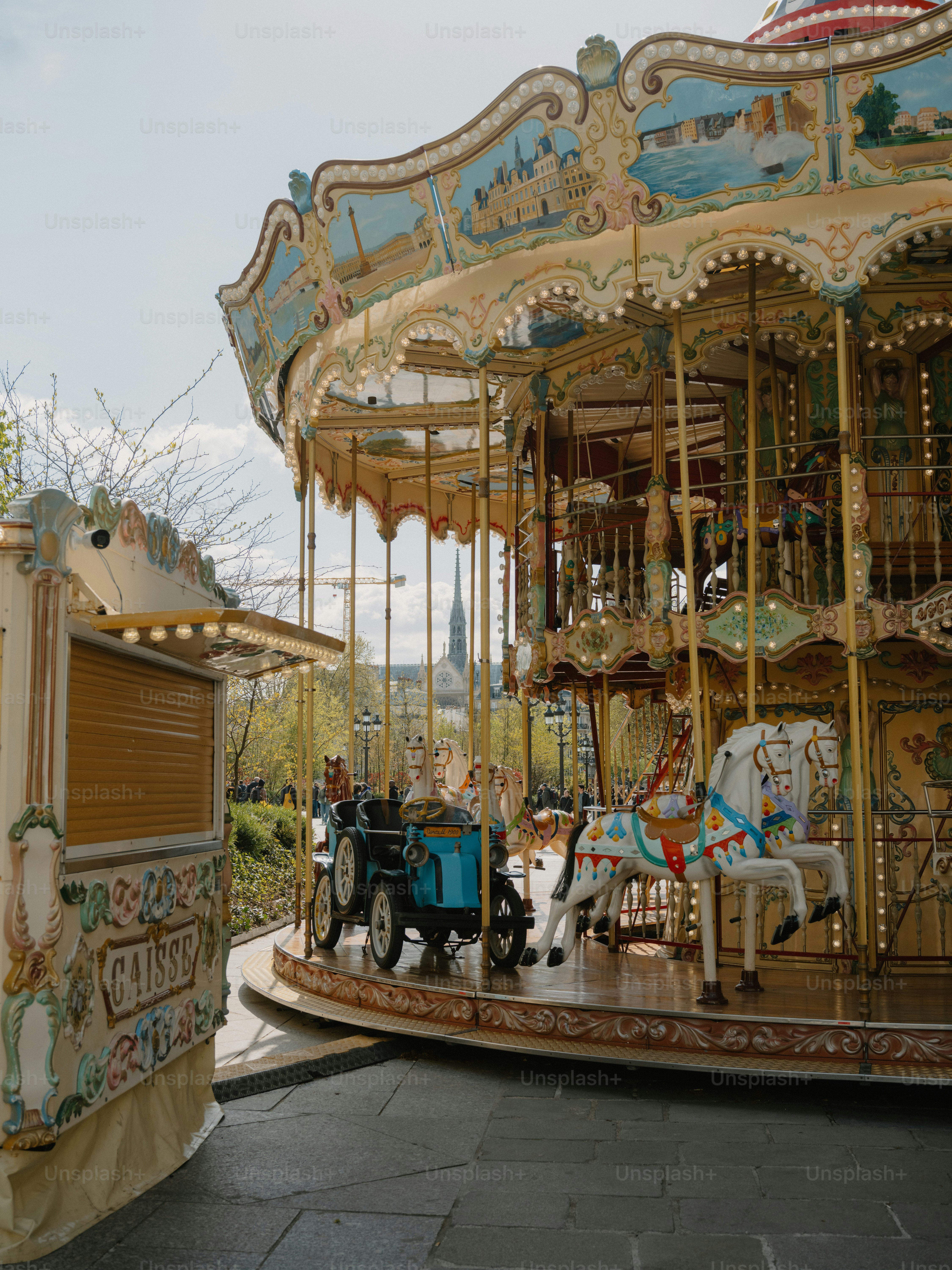 A colorful carousel with horses and a carriage