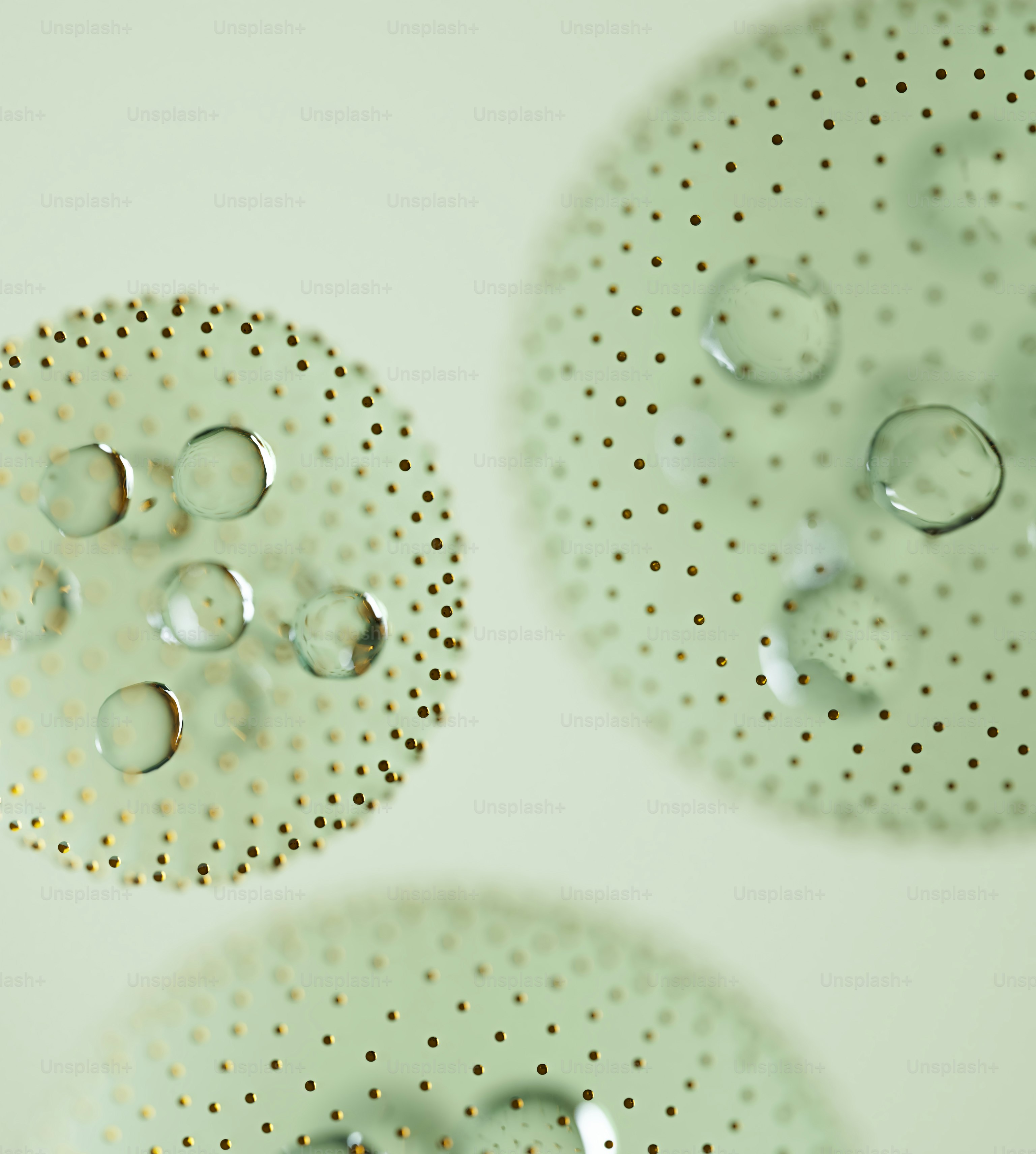 Tre forme astratte circolari con piccoli puntini e gocce d'acqua.