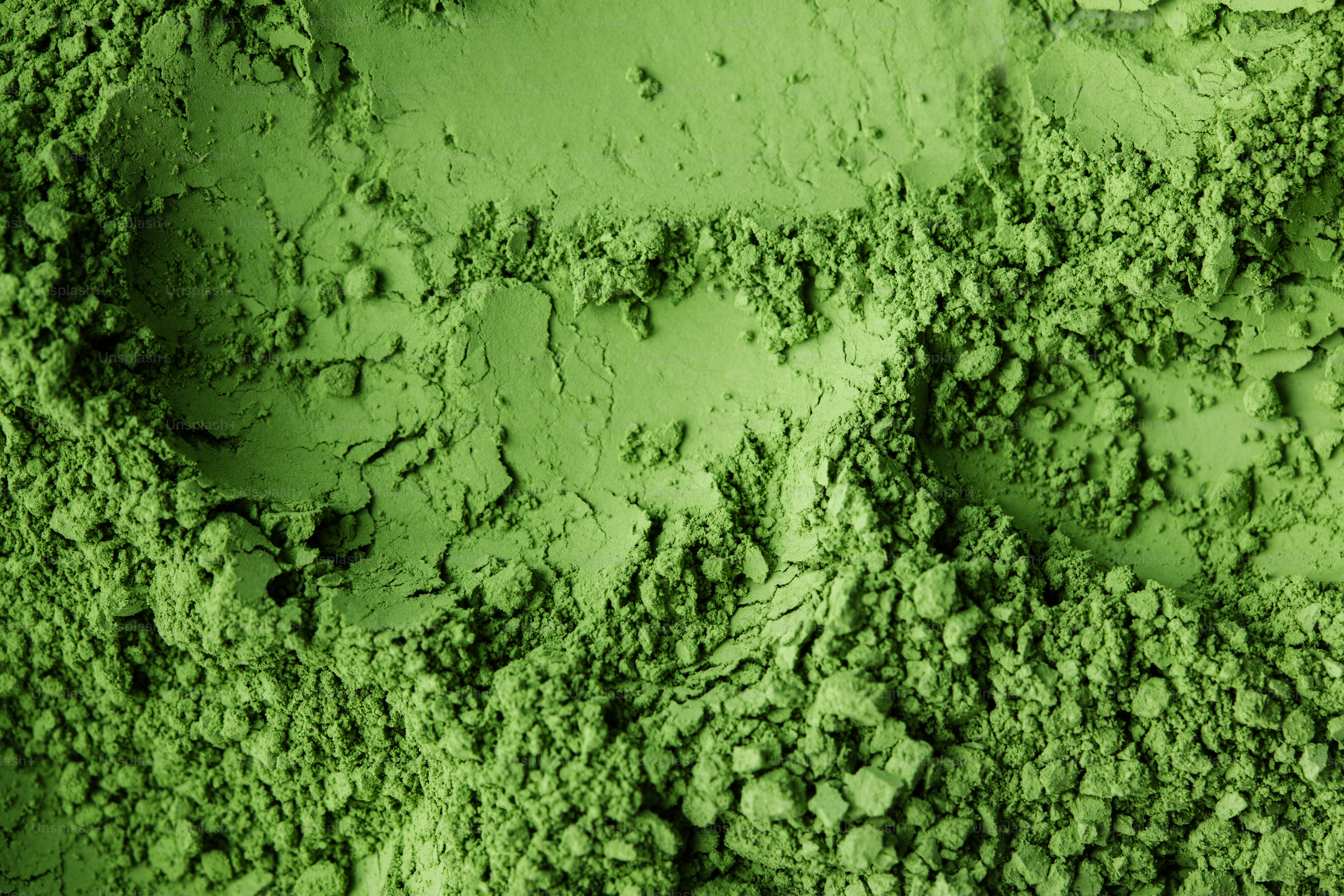 A close-up of bright green powder with visible texture.