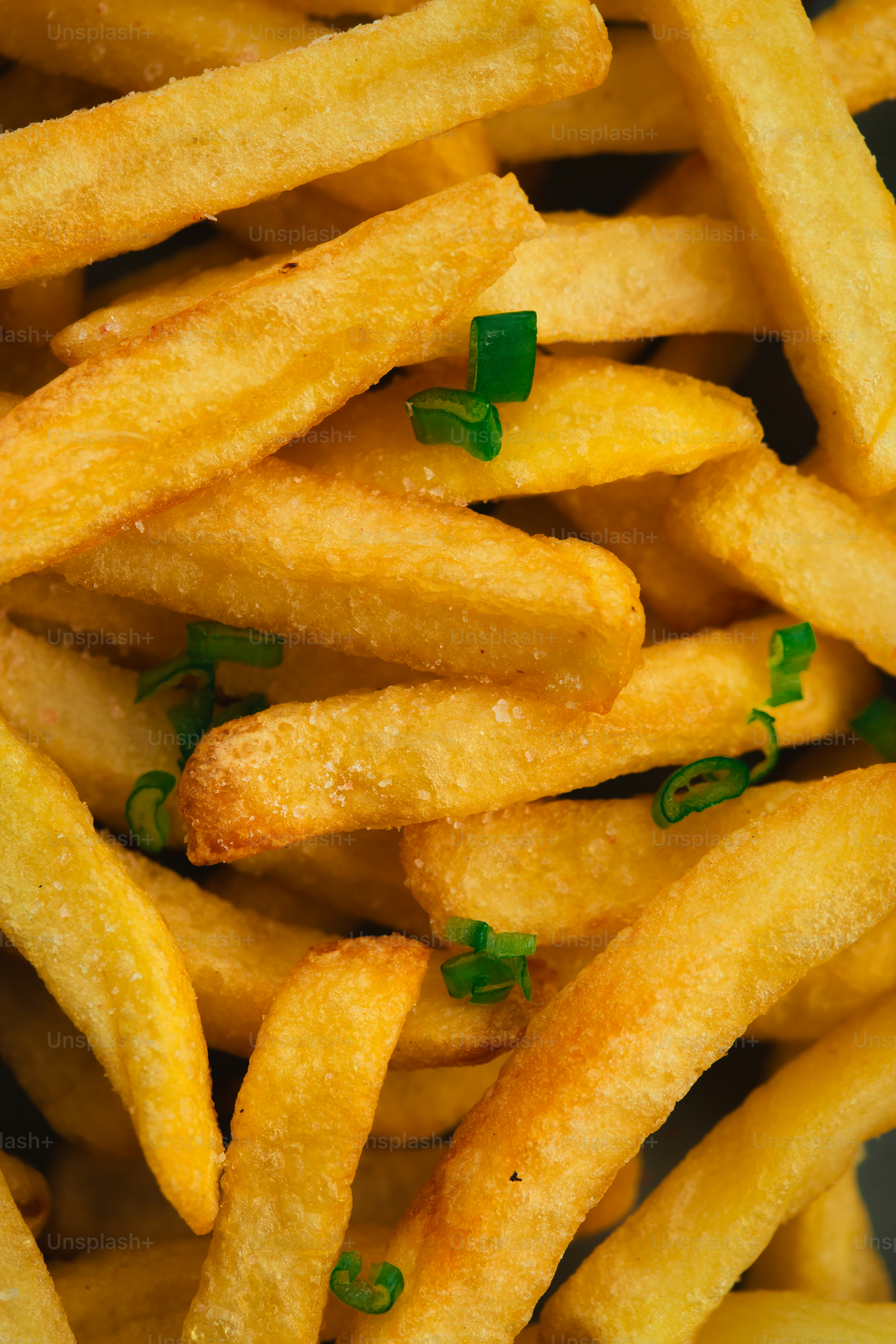 Golden french fries sprinkled with chopped green onions.