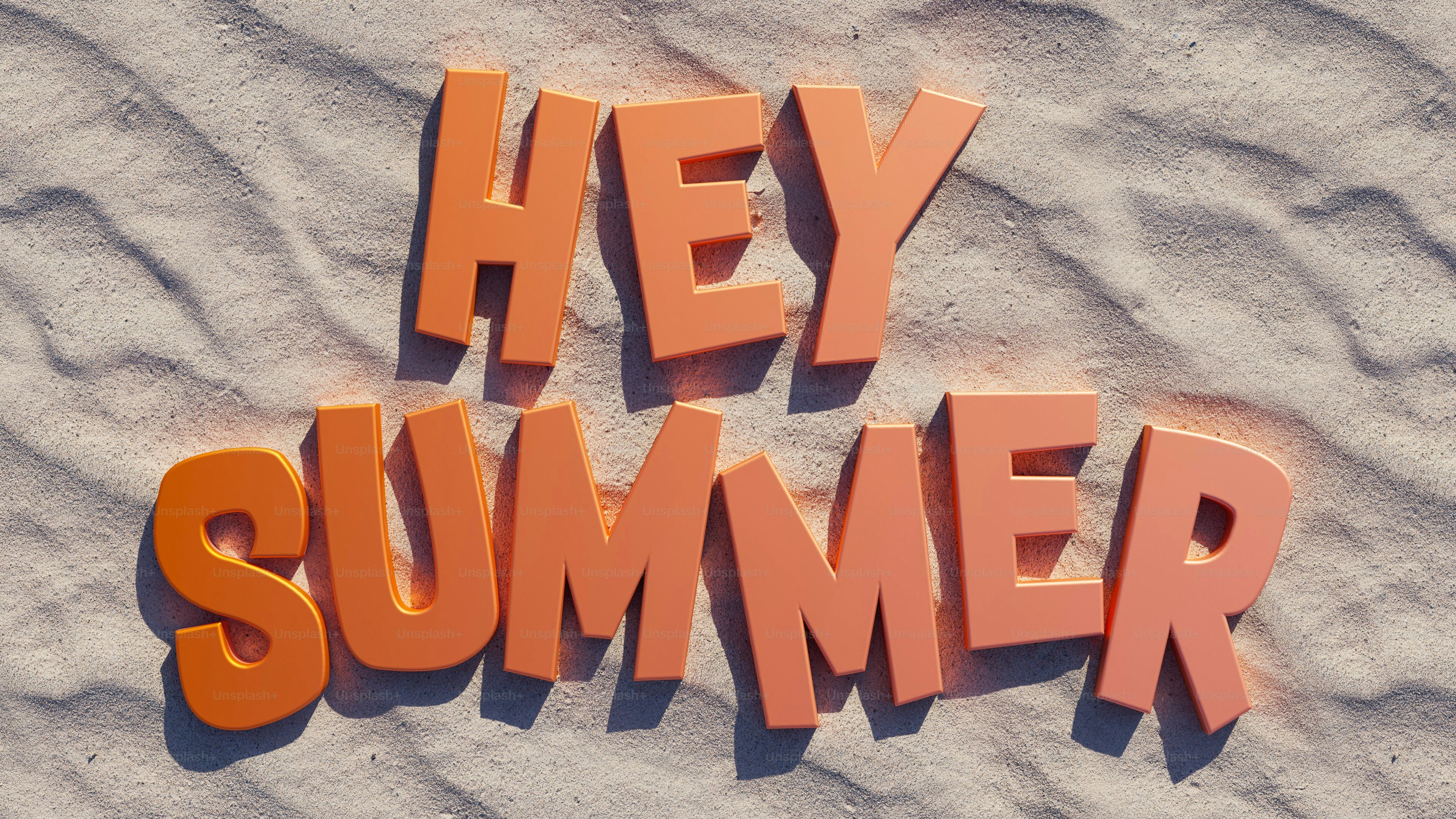 Orange letters spell "hey summer" on sand.