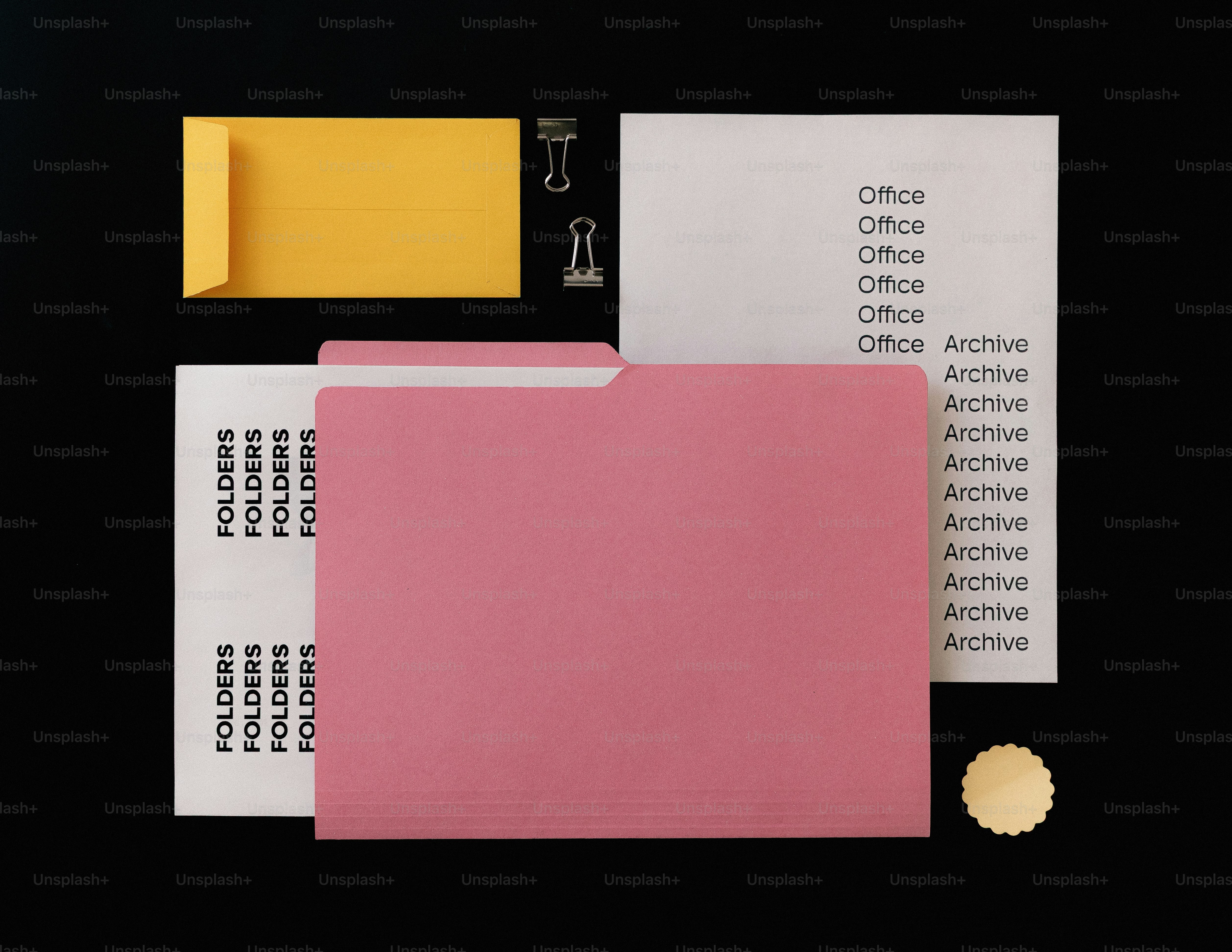 Office supplies including folders and envelope on black background