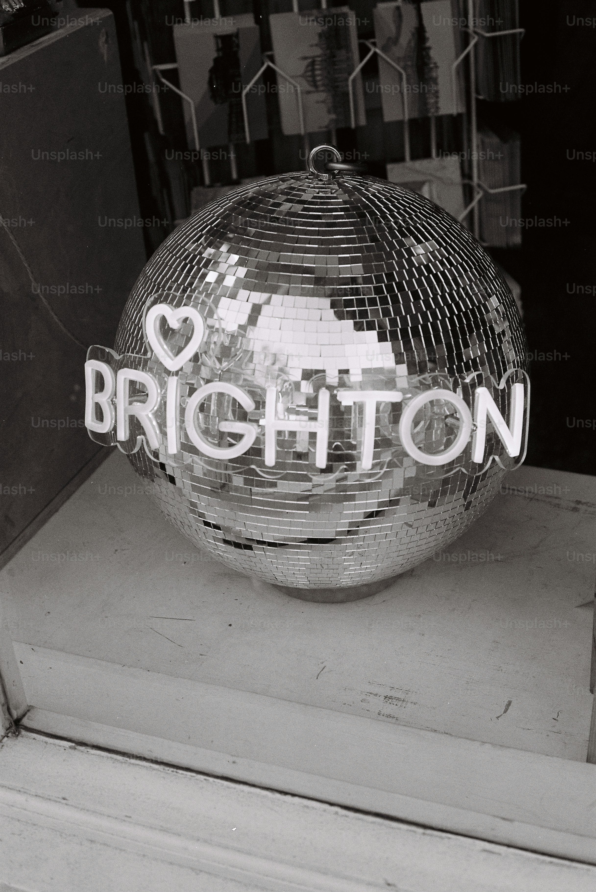 Disco ball with "i love brighton" neon sign
