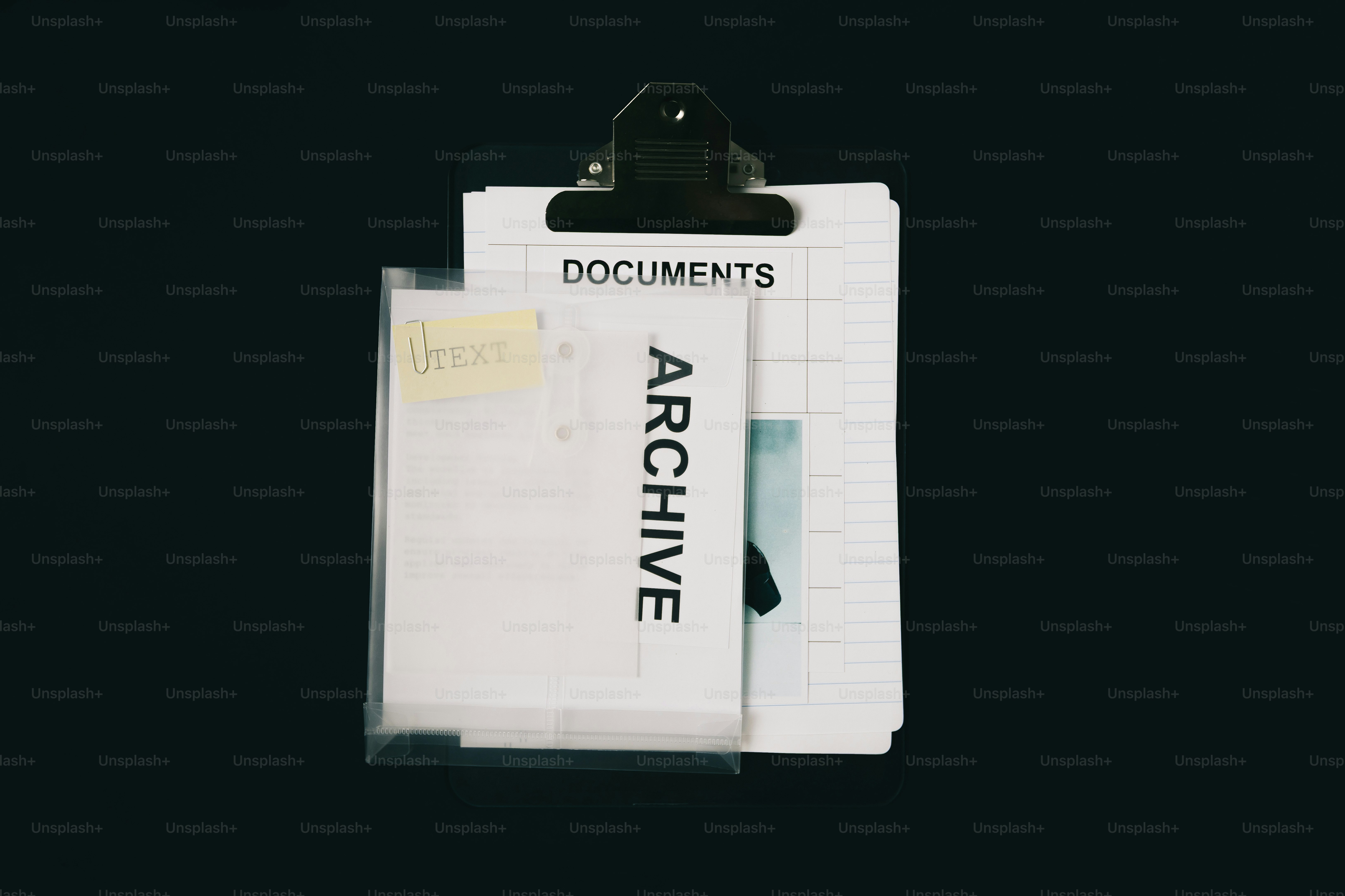 Clipboard holding documents labeled archive and documents