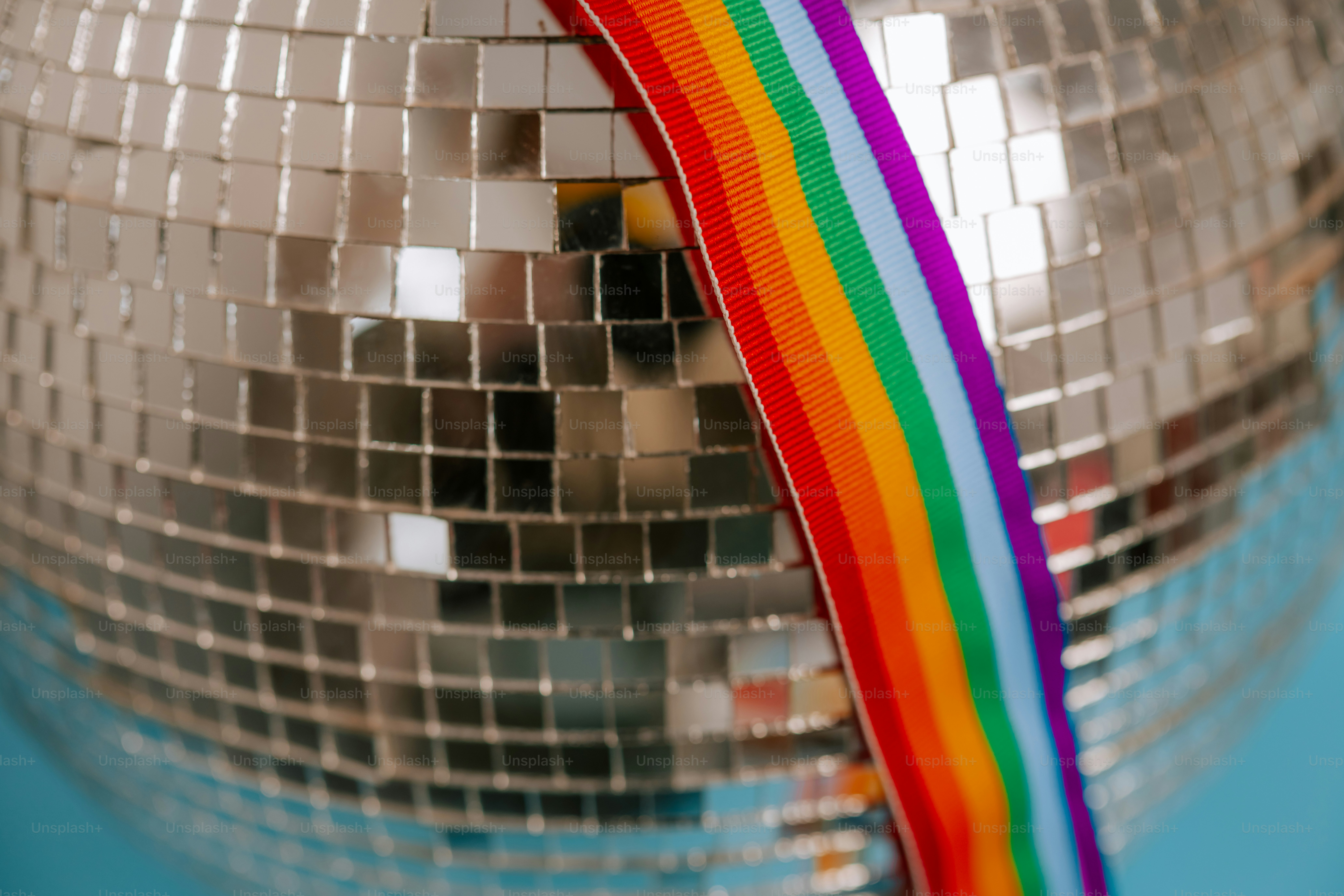 Disco ball with rainbow stripe on blue background