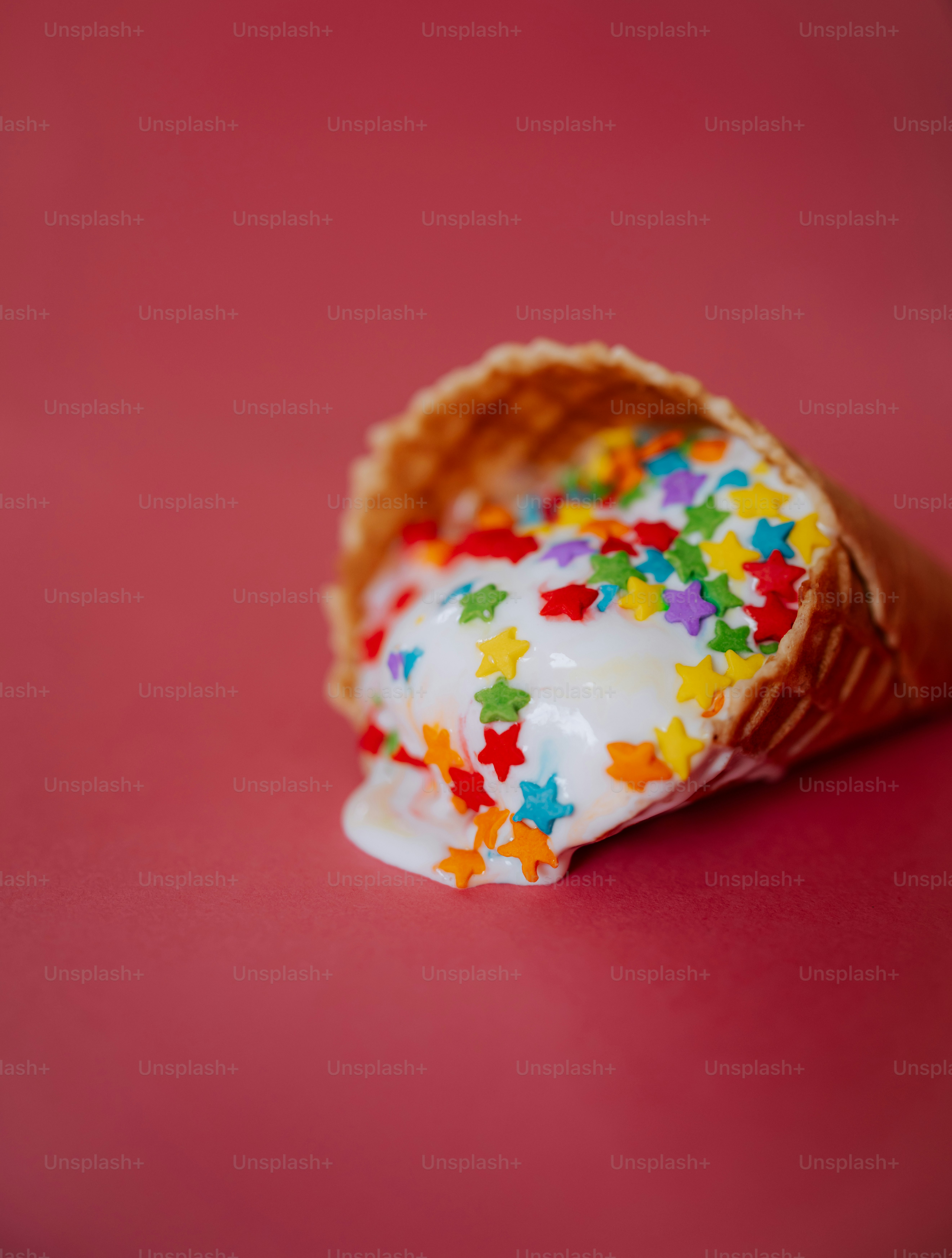 Melted ice cream with star sprinkles in a cone.