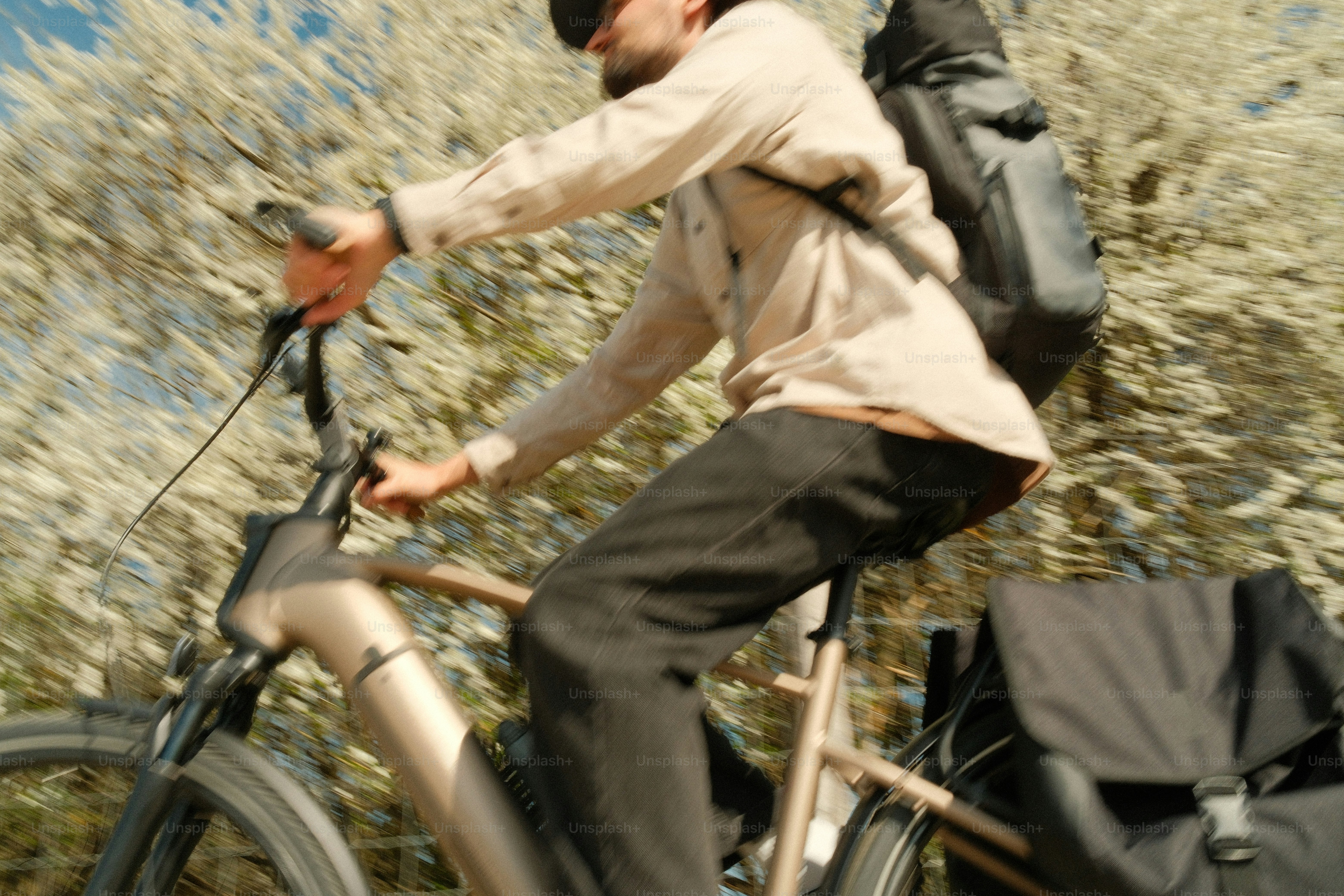 Man riding an electric bike with a backpack.