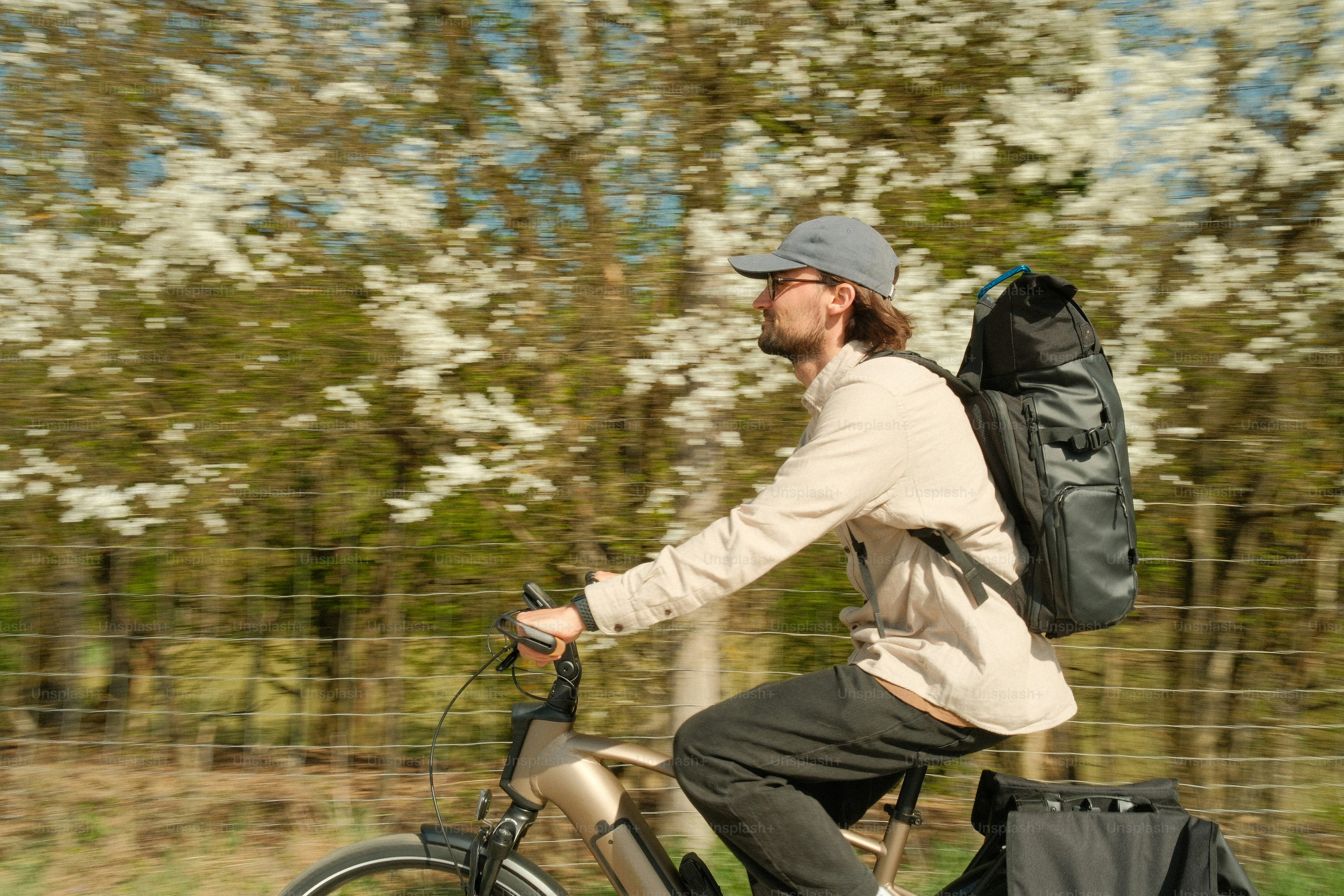 Man riding a bicycle with a backpack.