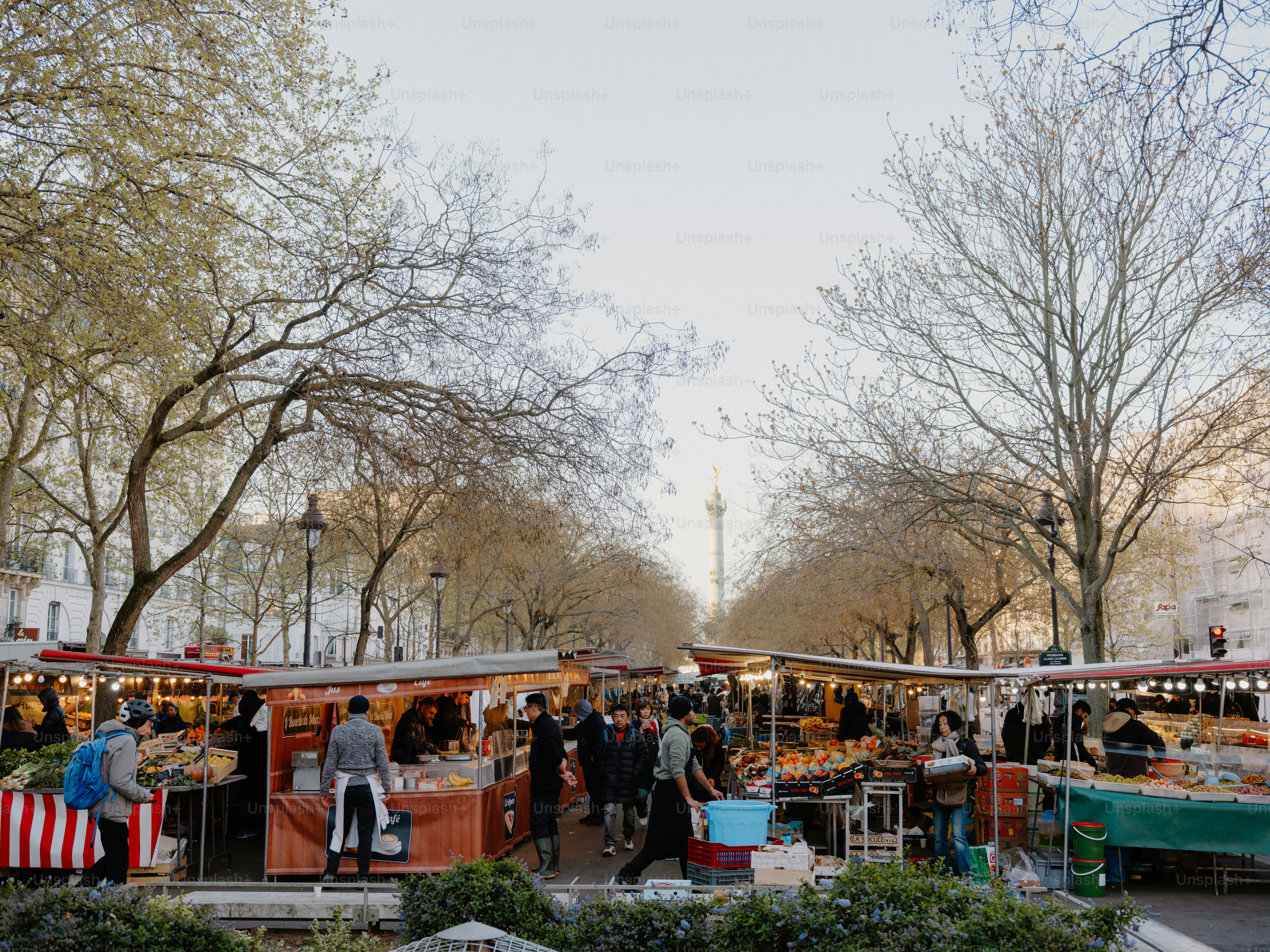 Outdoor market stalls with people browsing goods