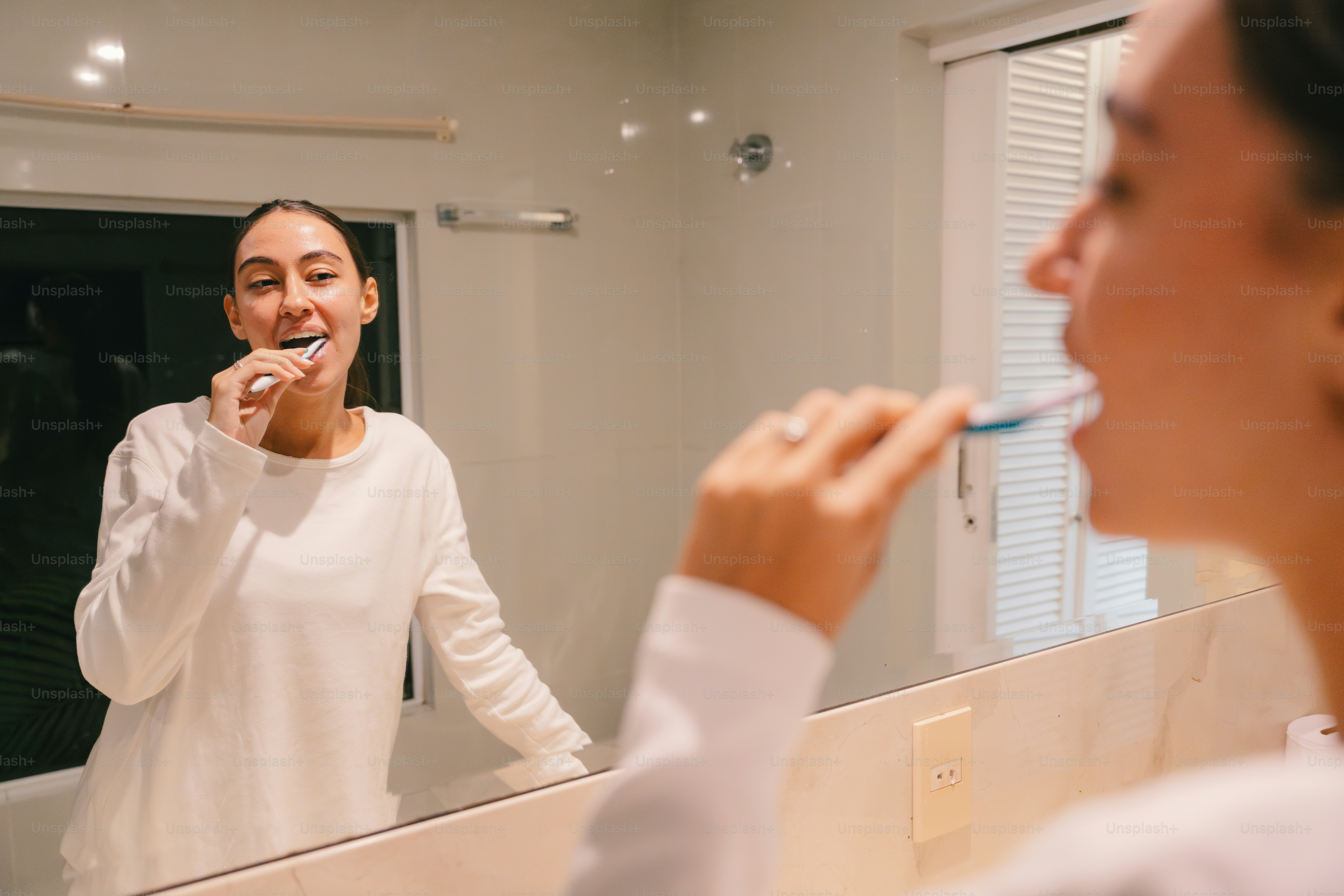 Woman brushing her teeth as part of an everyday oral care routine