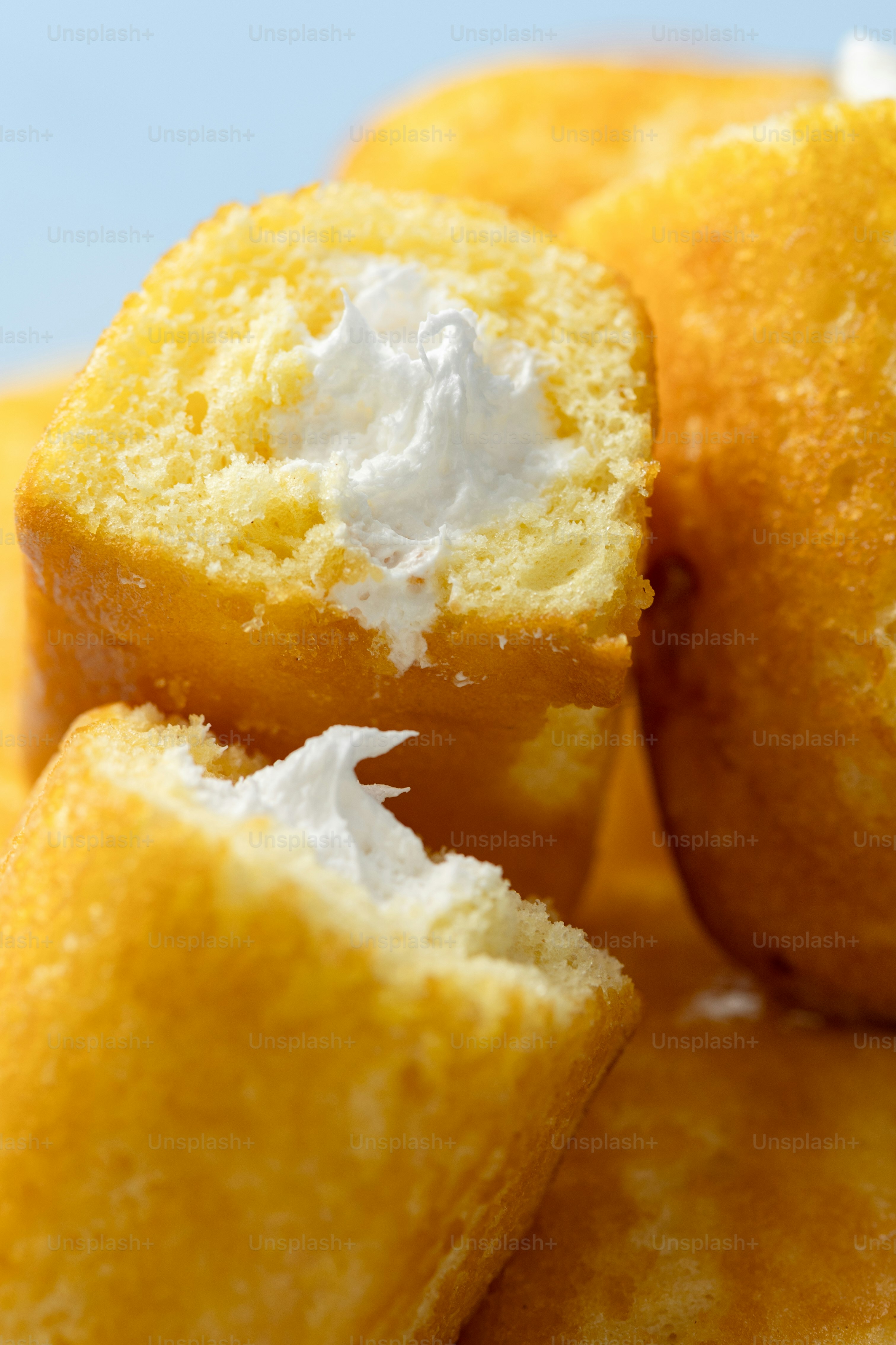 Golden sponge cakes filled with creamy white frosting