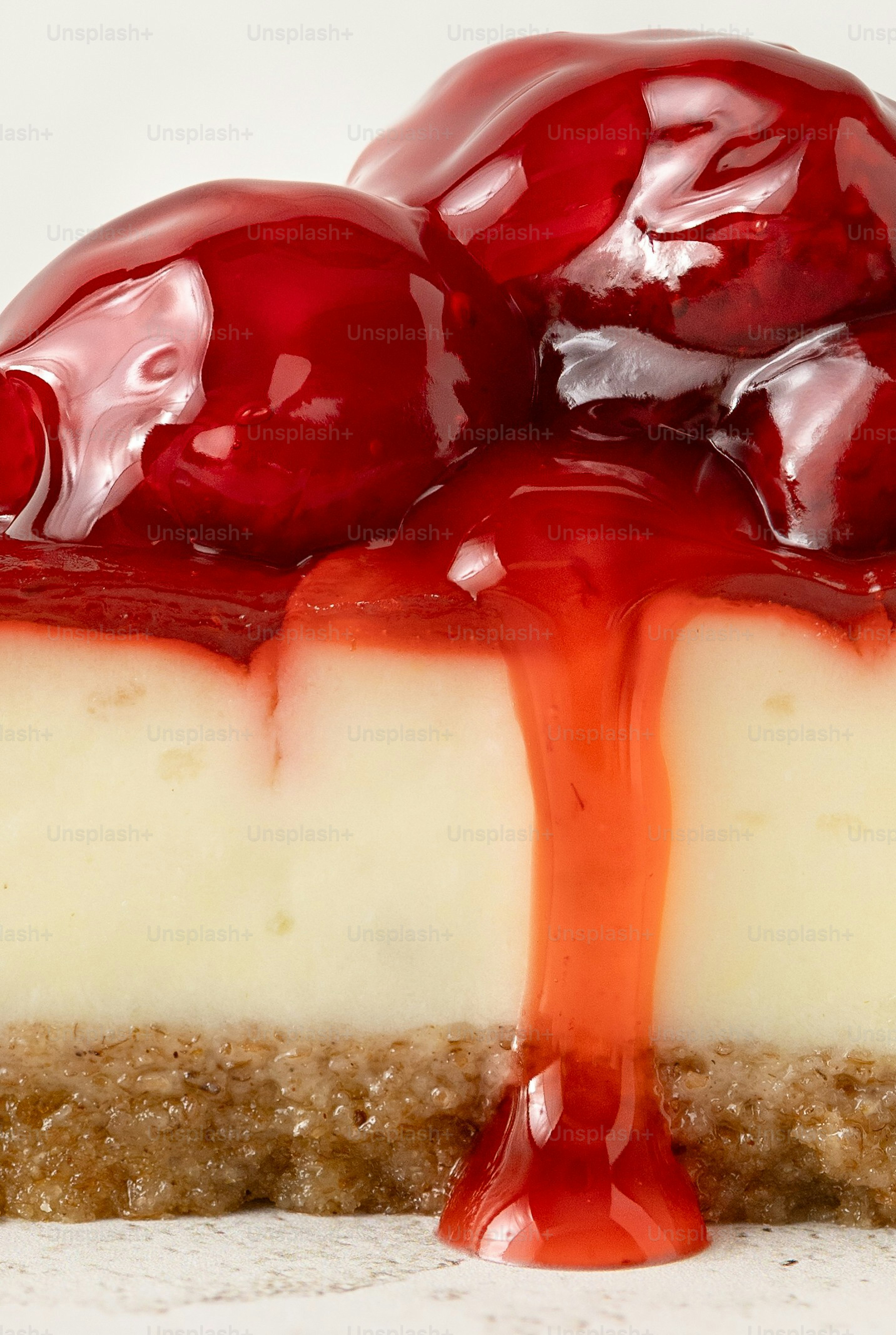 A slice of cheesecake topped with cherry sauce