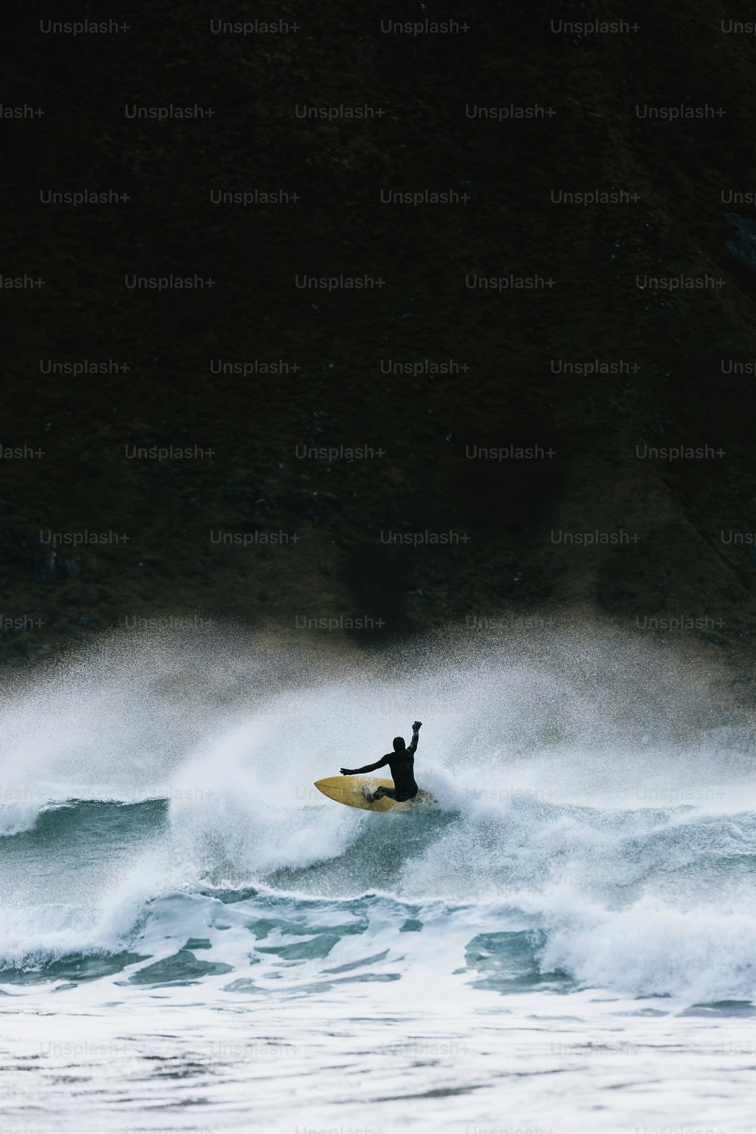 Surfer riding a wave with arms raised photo – Travel Image on Unsplash
