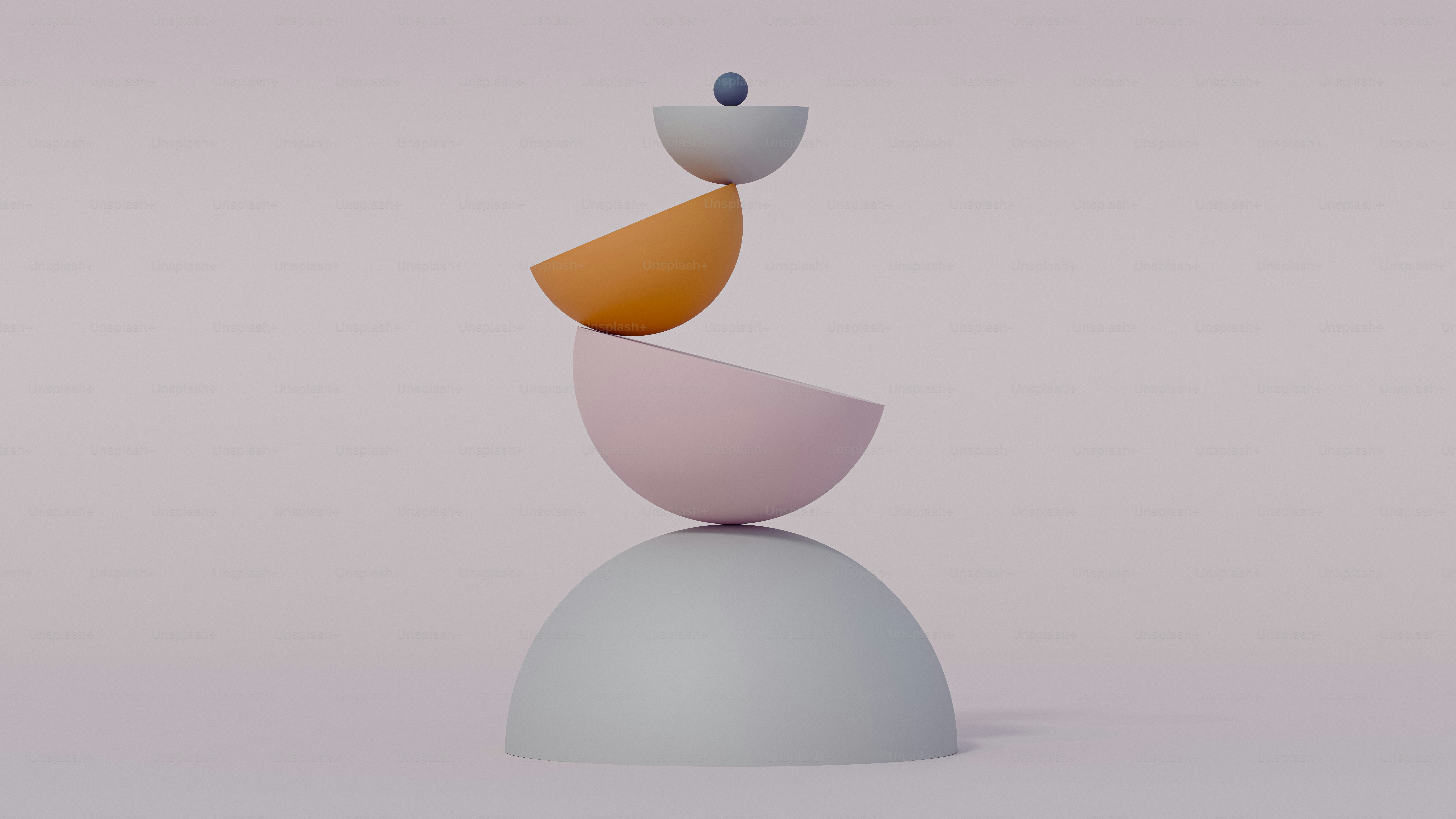 Stack of pastel colored geometric shapes balanced precariously