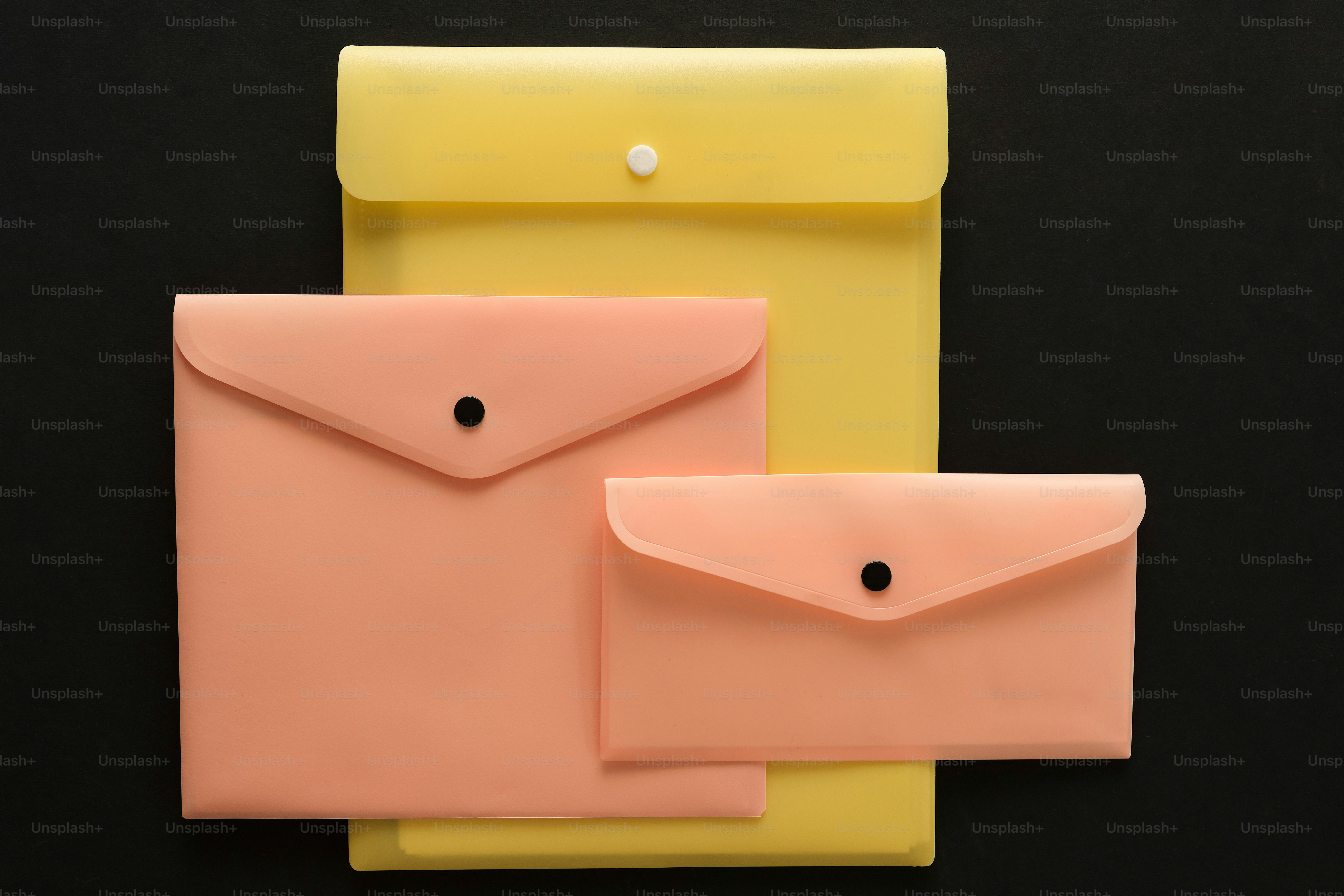 Assortment of colorful document folders on a peach background photo ...