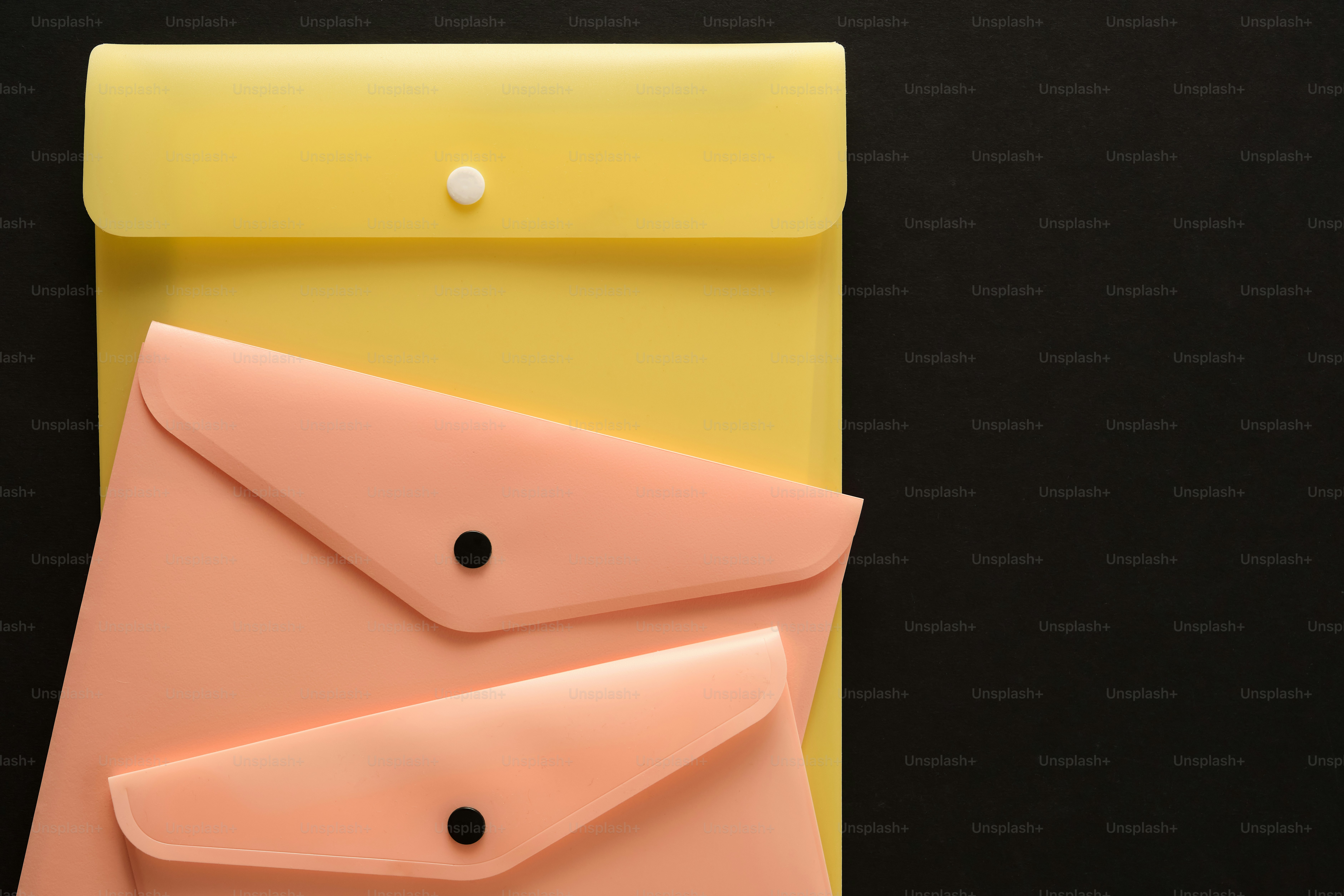 Assortment of colorful document folders on a peach background photo ...