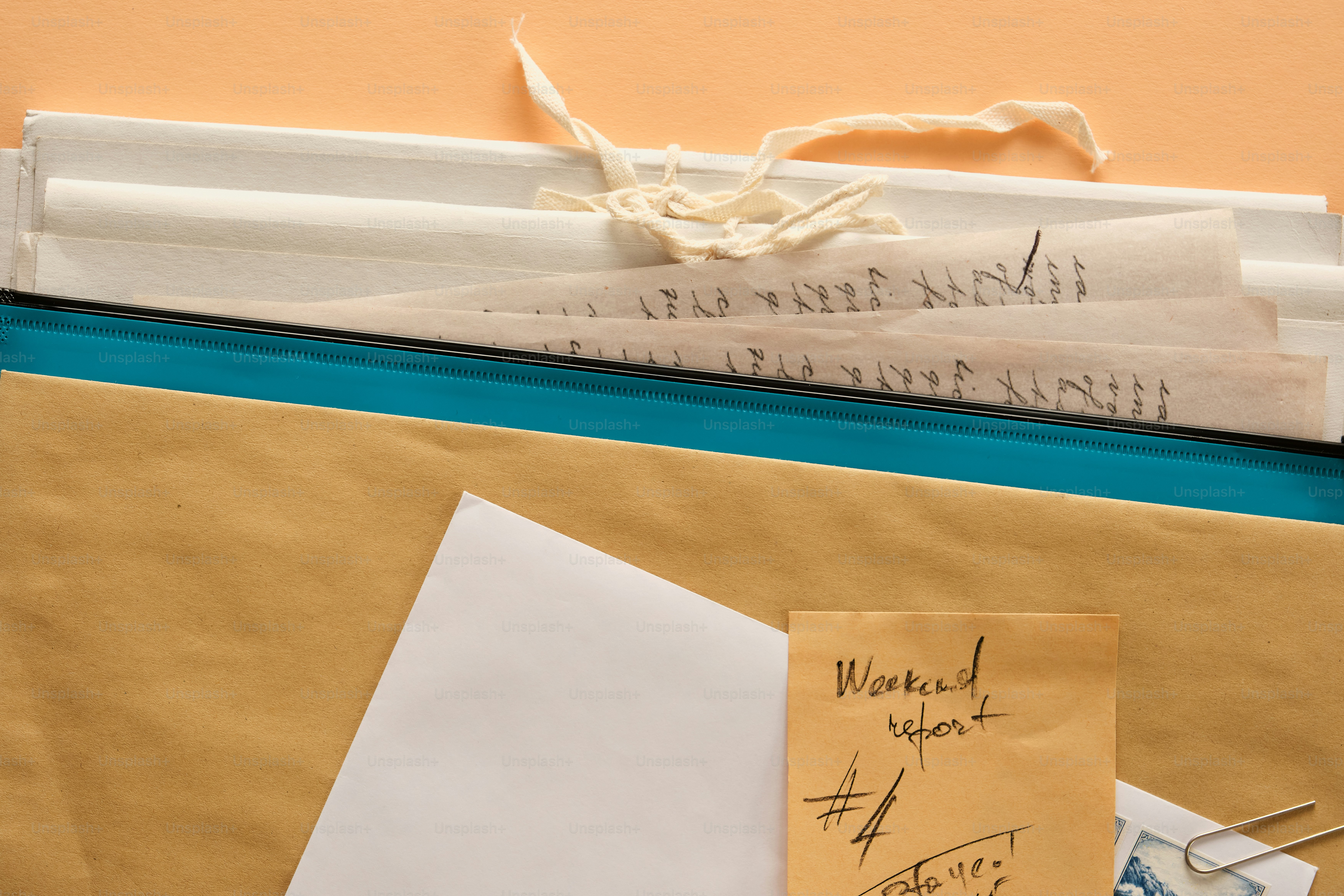 Documents and notes scattered on a white surface. photo – Business ...