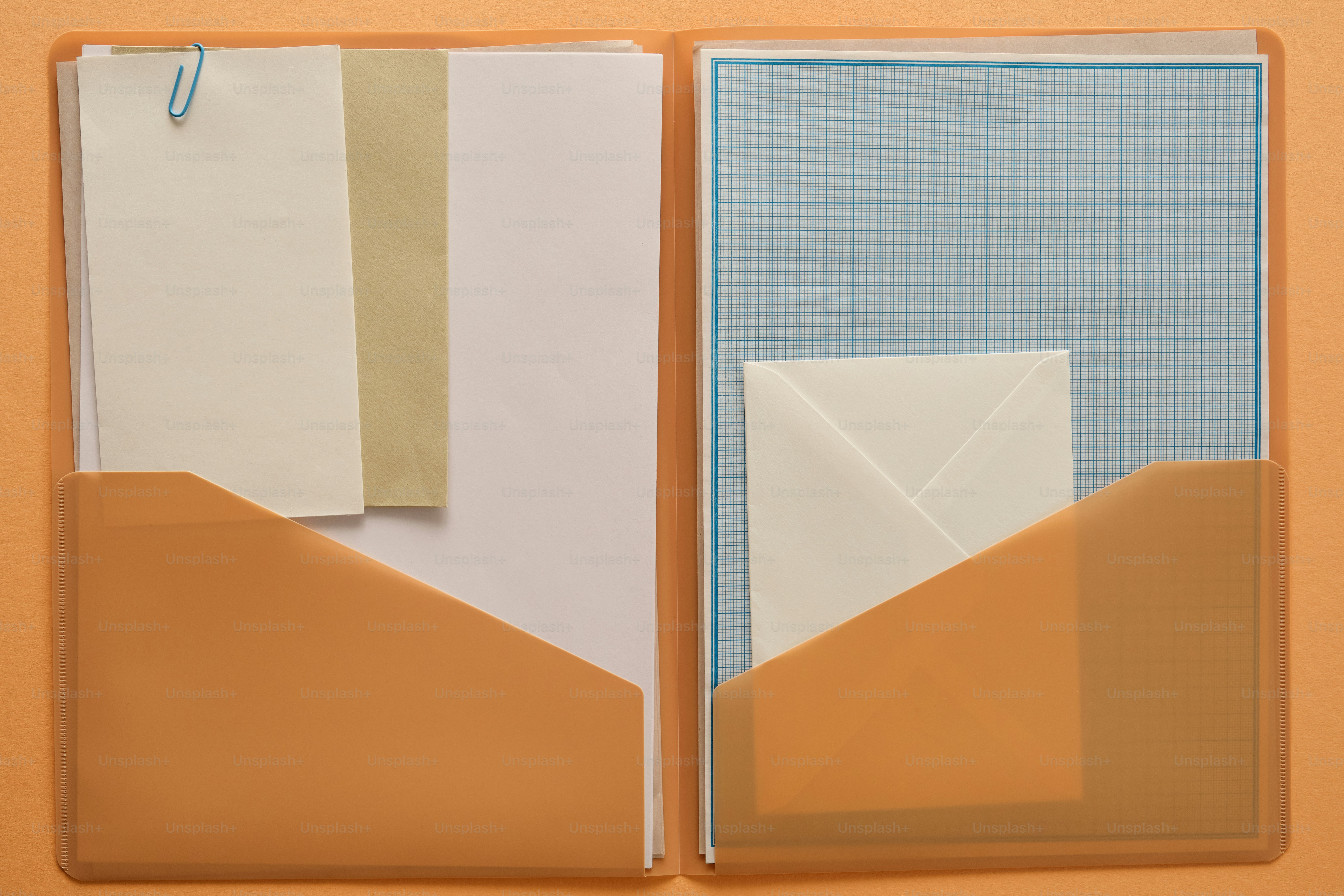 An open folder with papers and an envelope. photo – Paper Image on Unsplash